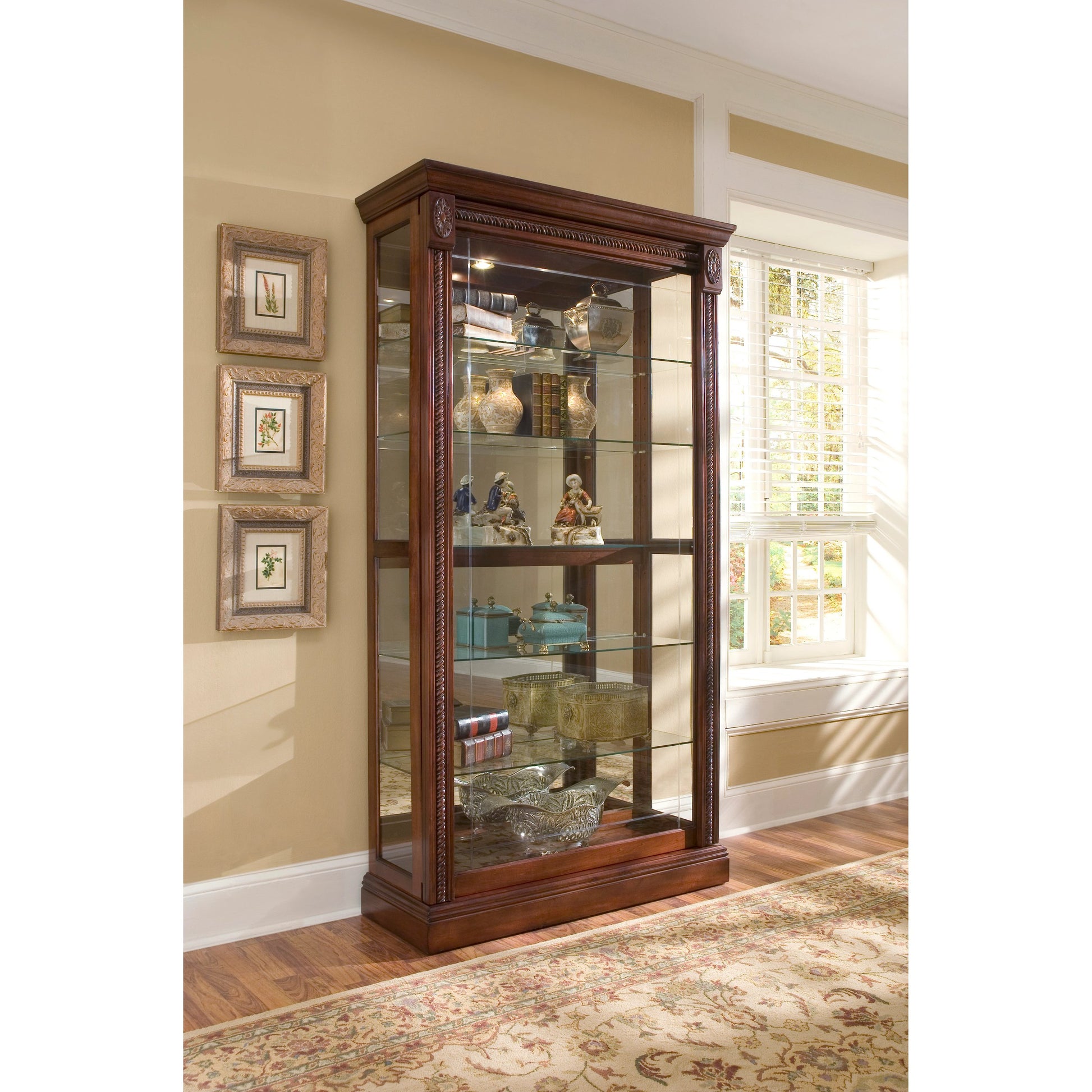43'' Wide Medallion Cherry Curio Display Cabinet by Pulaski Furniture in rich cherry. Made from hardwood solids in a traditional style.