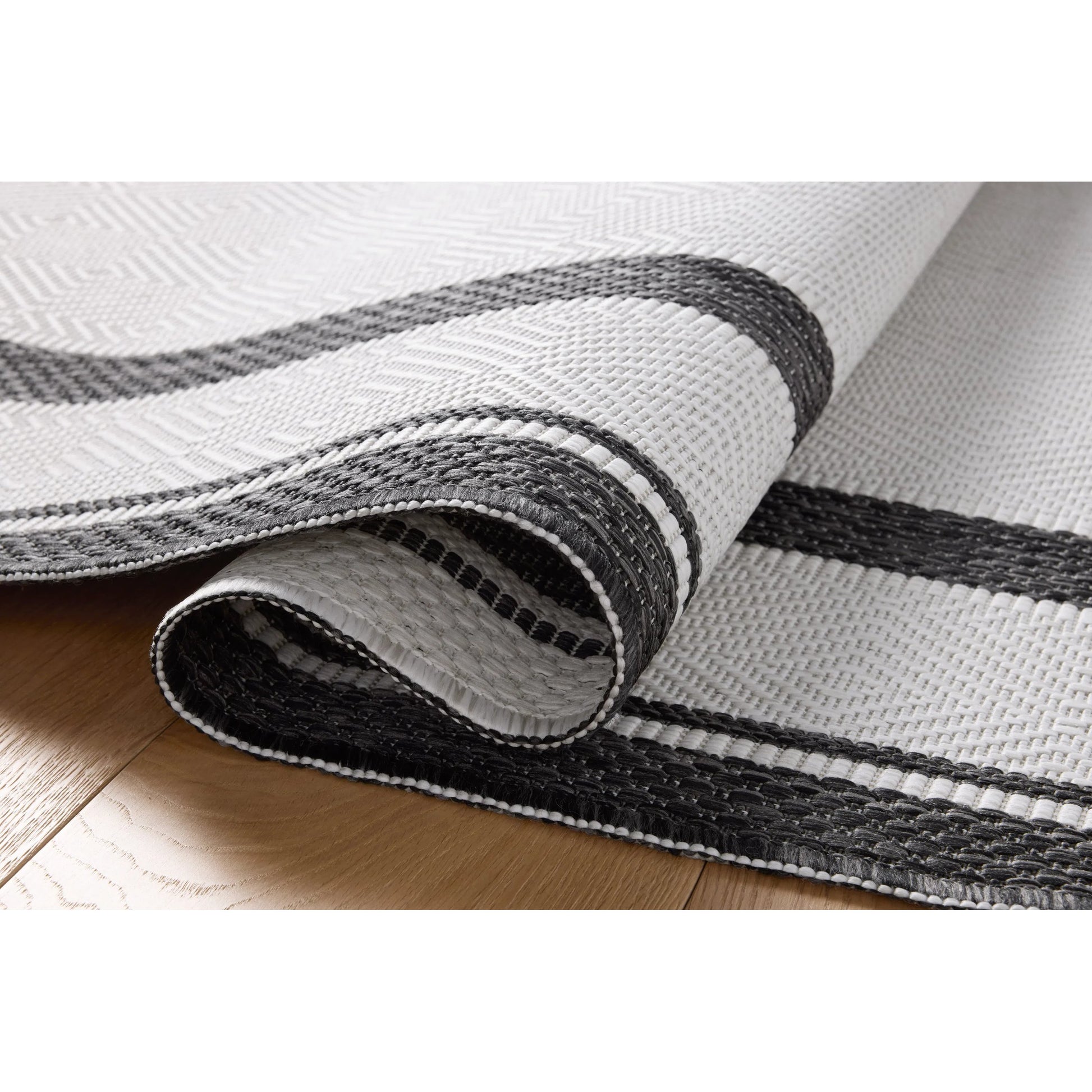 Easton ESN-11 Outdoor Rug by Loloi in onyx, ivory. Made from 100% polypropylene in a unique style.