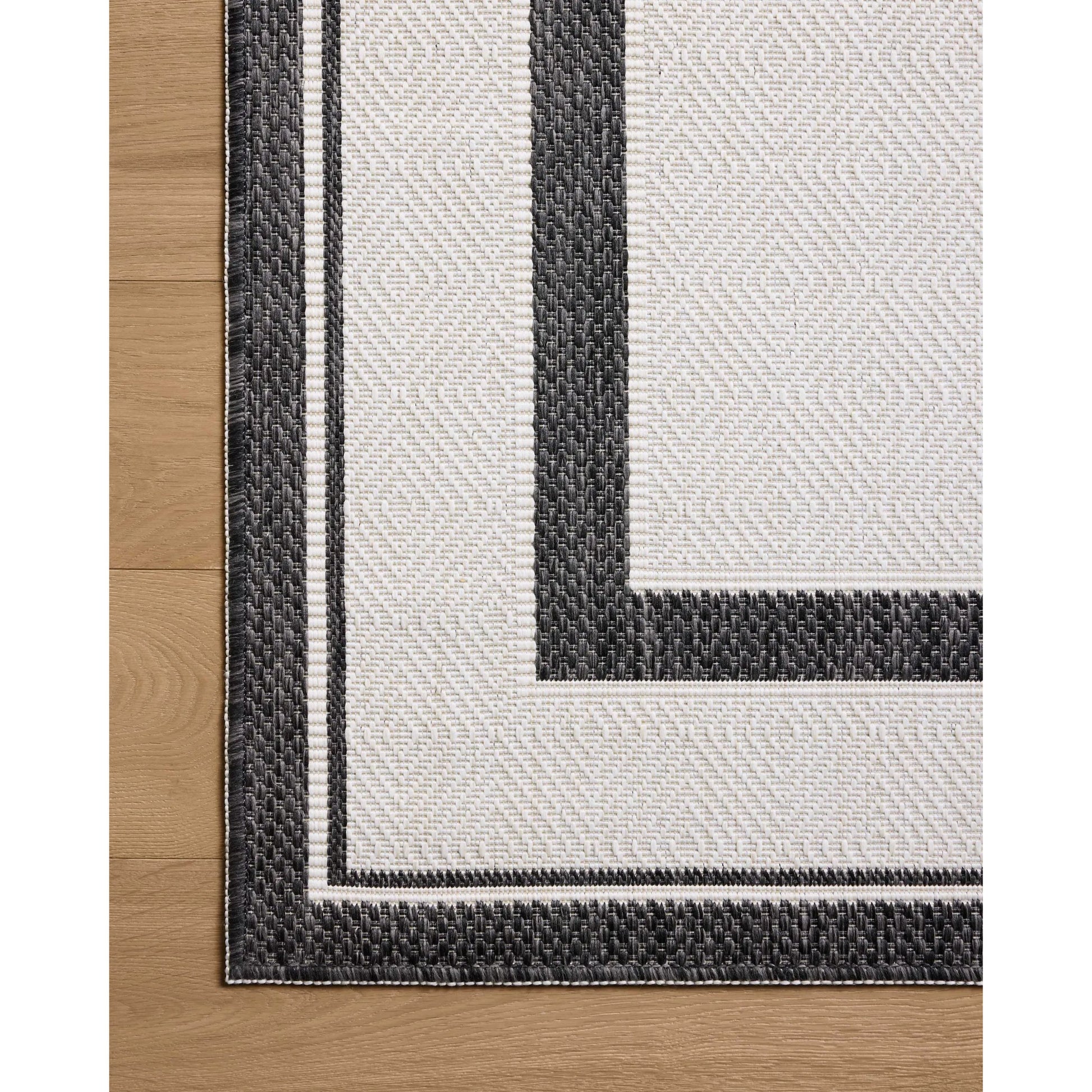 Easton ESN-11 Outdoor Rug by Loloi in onyx, ivory. Made from 100% polypropylene in a unique style.