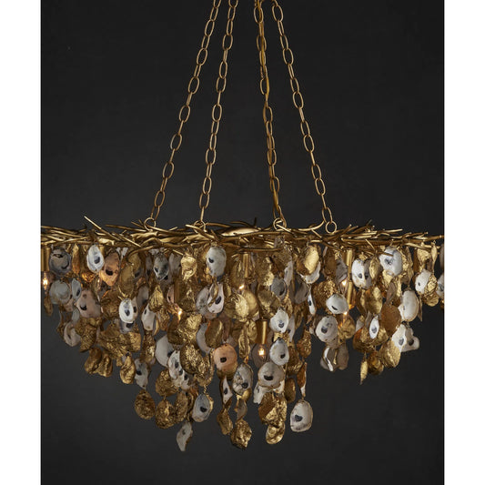 Lucullan Chandelier by Currey and Company in contemporary gold leaf, contemporary gold, natural. Made from wrought iron, oyster shells in a unique style.