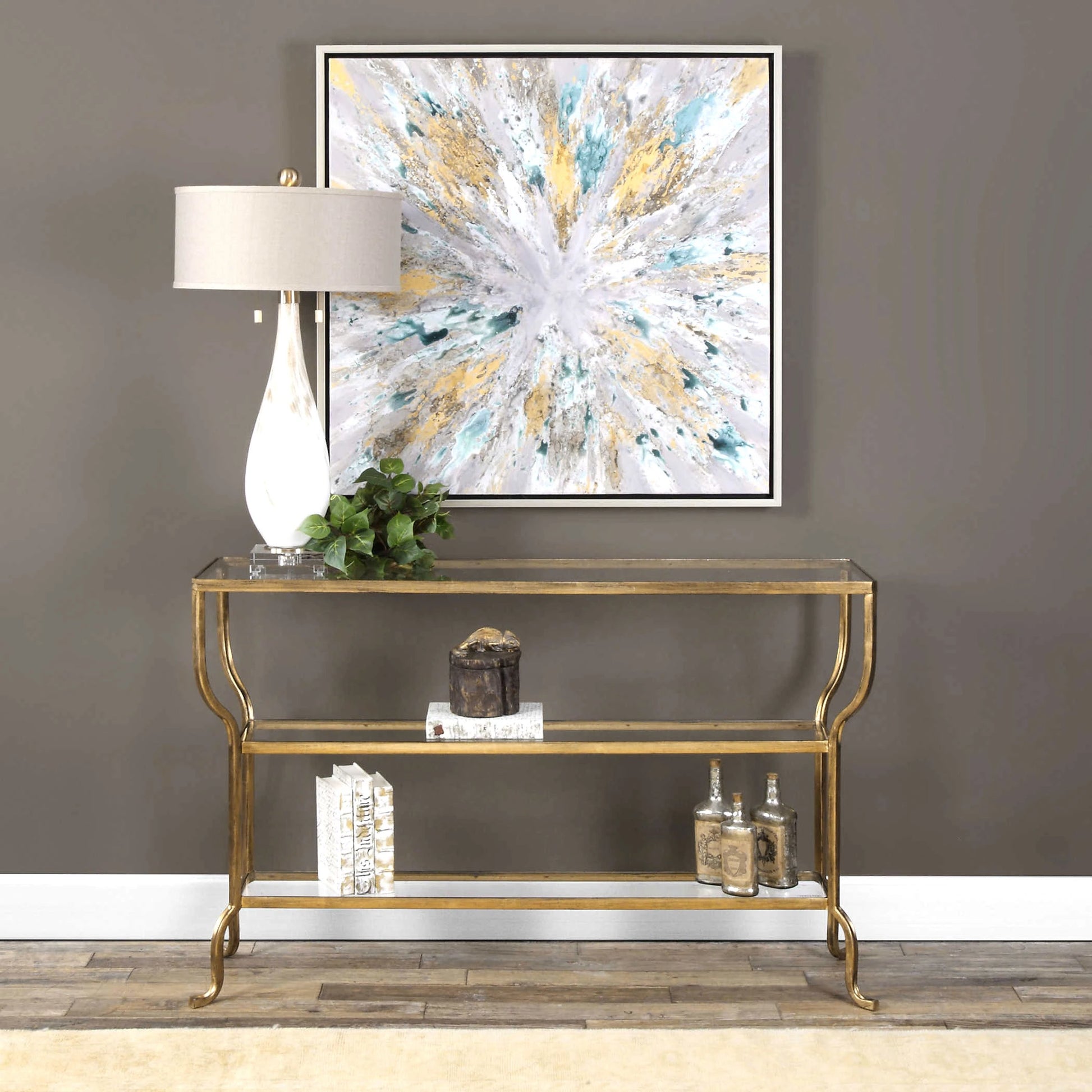 Deline Console Table by Uttermost in gold. Made from iron, glass in a modern style.