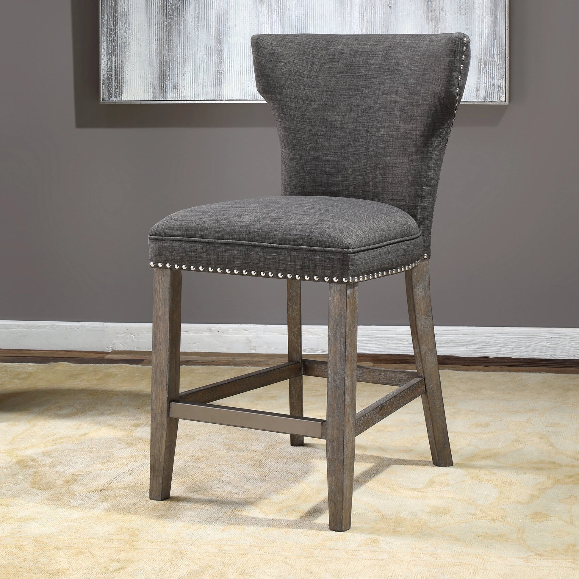 Arnaud Charcoal Counter Stool by Uttermost in charcoal. Made from solid wood, plywood, fabric, foam in a cottage & farmhouse style.