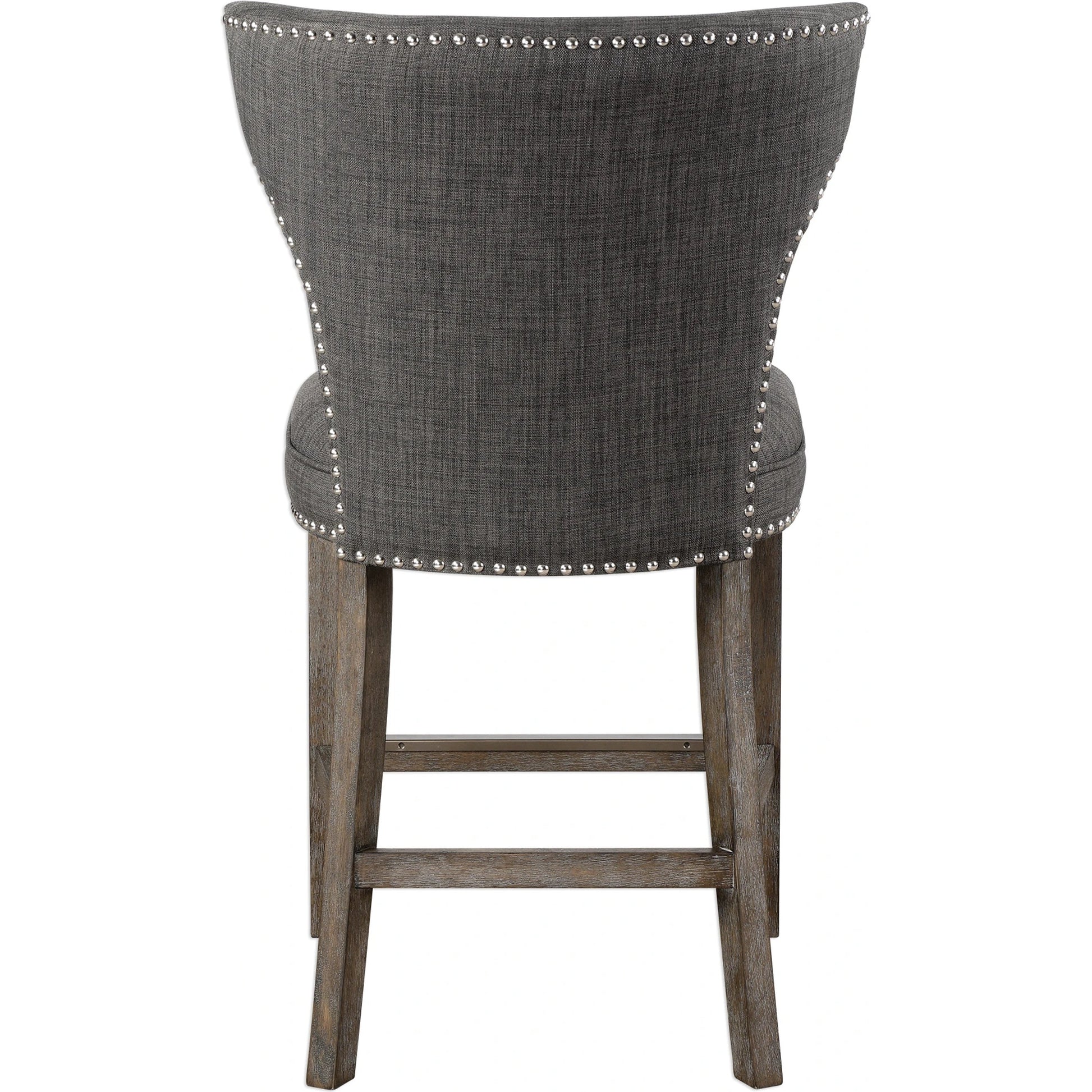 Arnaud Charcoal Counter Stool by Uttermost in charcoal. Made from solid wood, plywood, fabric, foam in a cottage & farmhouse style.