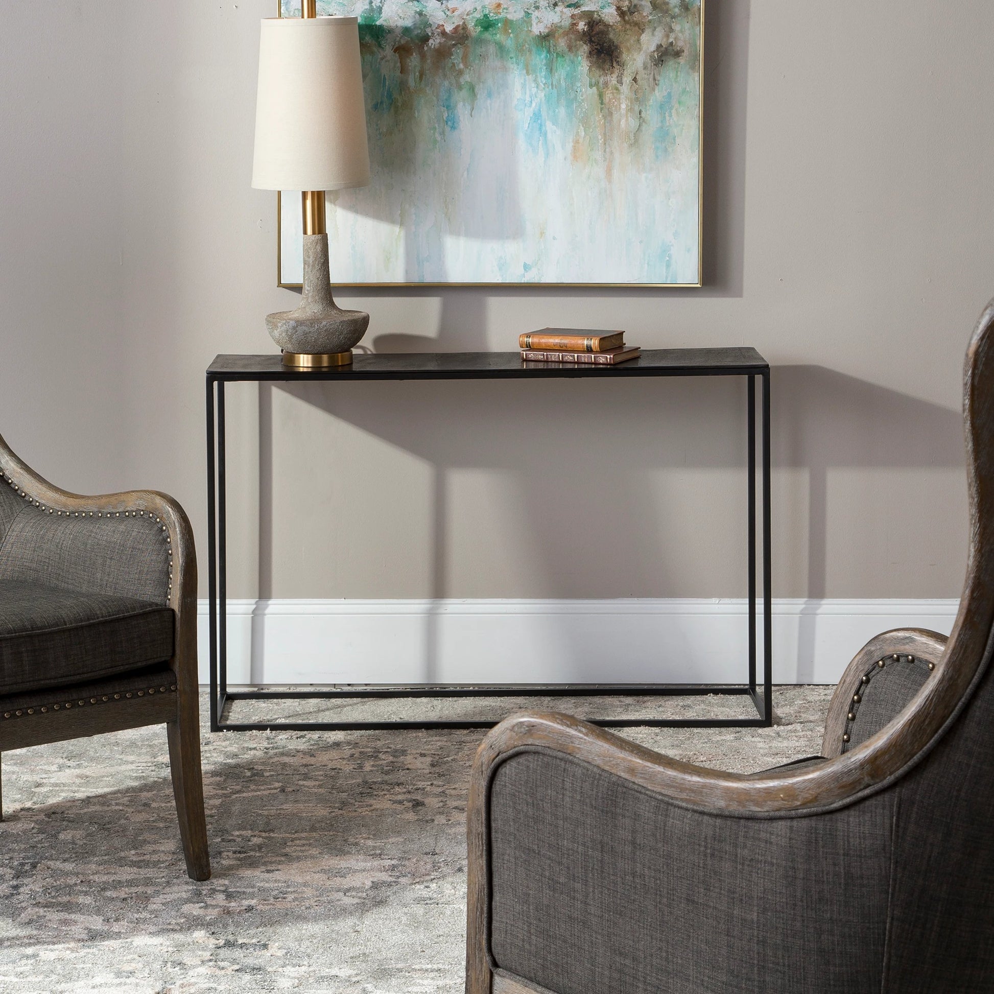 Coreene Console Table by Uttermost in aged black, antique bronze. Made from aluminum, iron in a modern style.