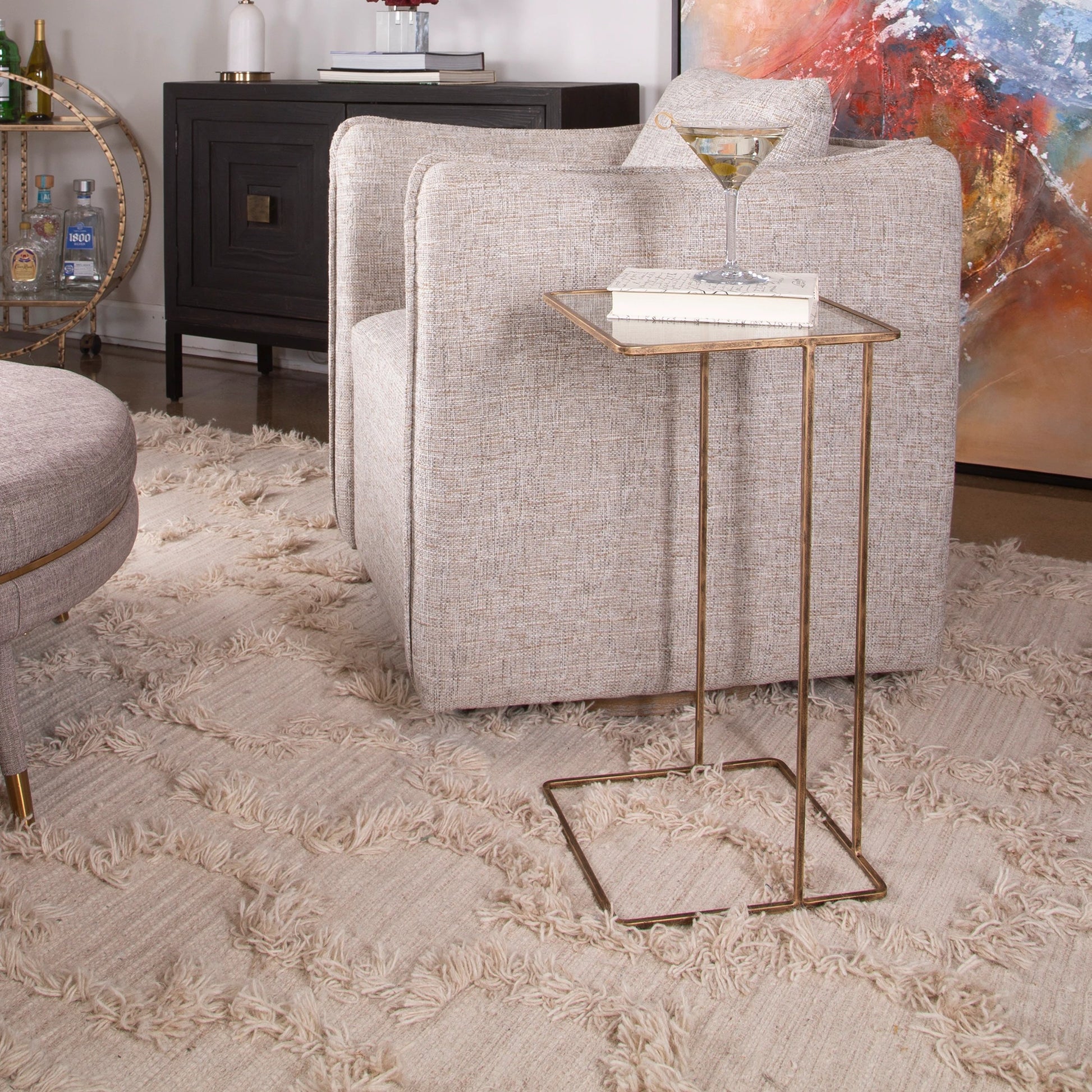Cadmus Table by Uttermost in gold. Made from iron, glass in a modern style.