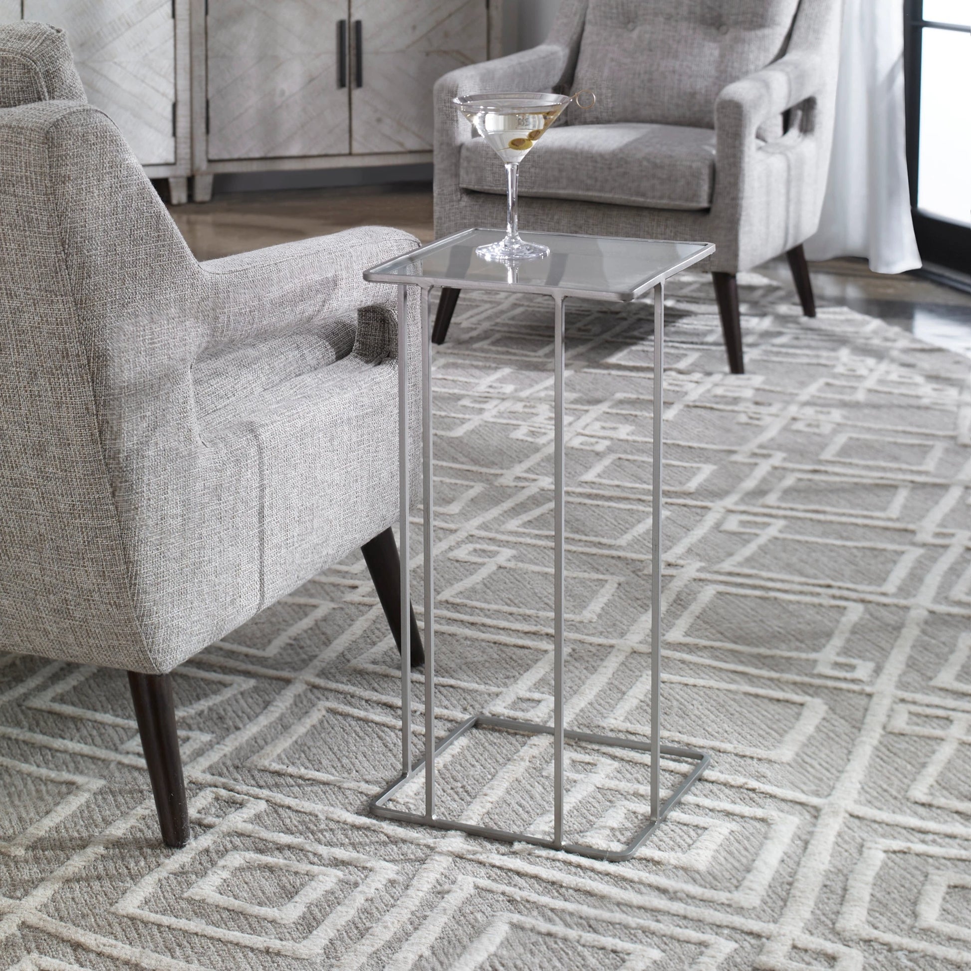 Cadmus Accent Table by Uttermost in black. Made from iron, glass in a modern style.