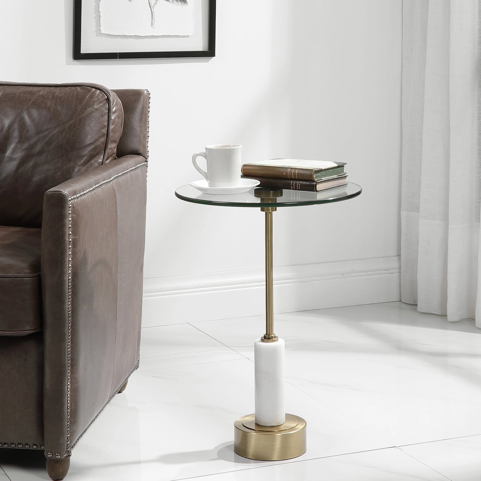 Portsmouth Accent Table by Uttermost in brushed brass. Made from iron, marble, glass in a modern style.