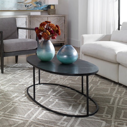 Coreene Oval Coffee Table by Uttermost in antique black. Made from iron, aluminum in a transitional style.