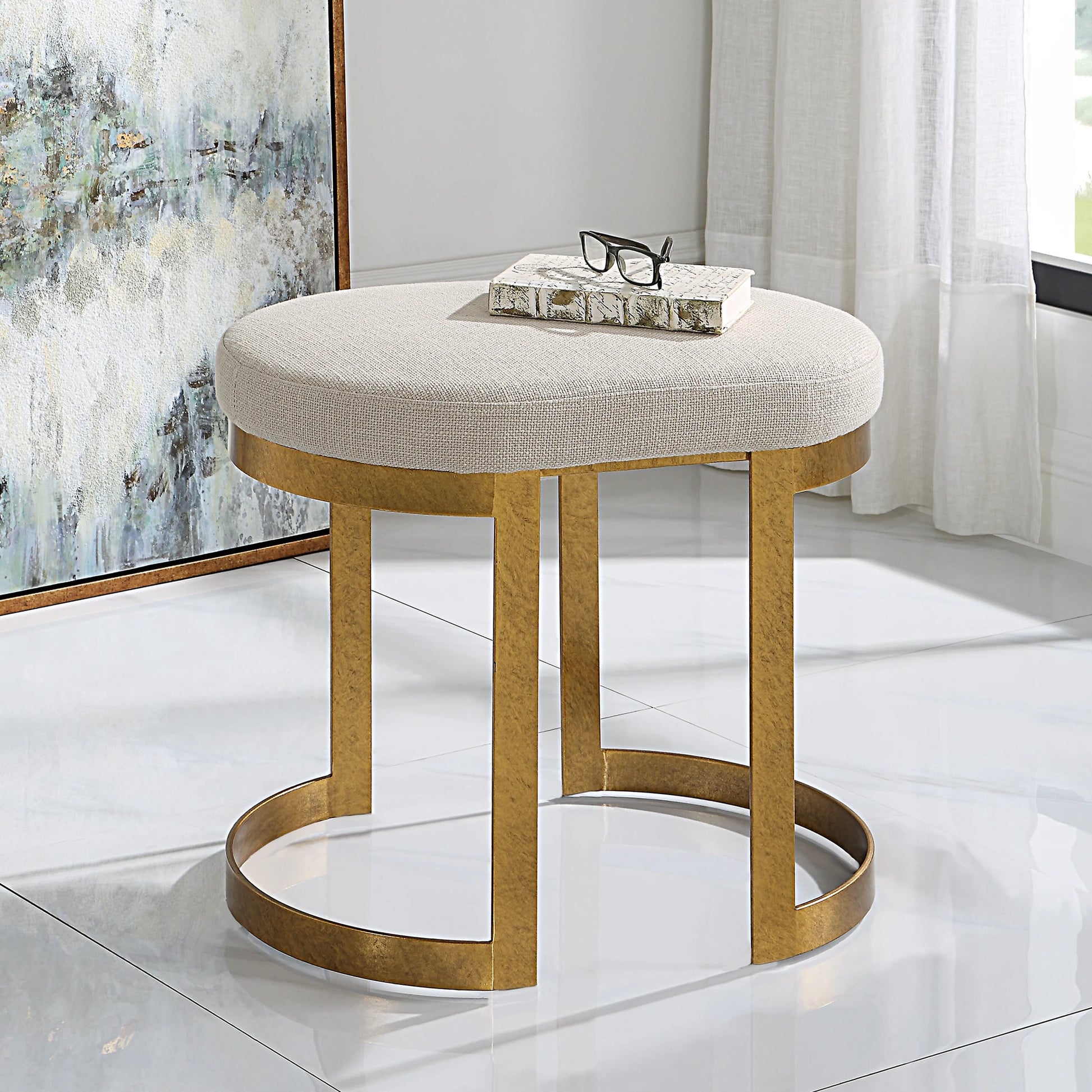 Infinity Accent Stool by Uttermost in gold. Made from metal, mdf, foam, fabric in a modern style.
