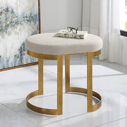 Infinity Accent Stool by Uttermost in gold. Made from metal, mdf, foam, fabric in a modern style.
