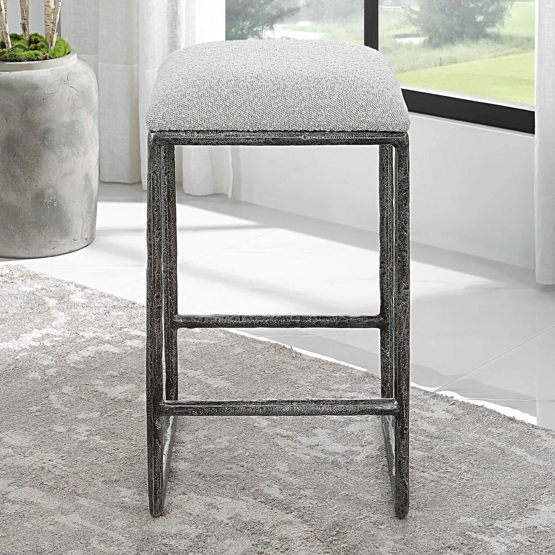 Brisbane Counter Stool by Uttermost in ivory, gray and charcoal. Made from cast iron, mdf, foam, fabric in a modern style.