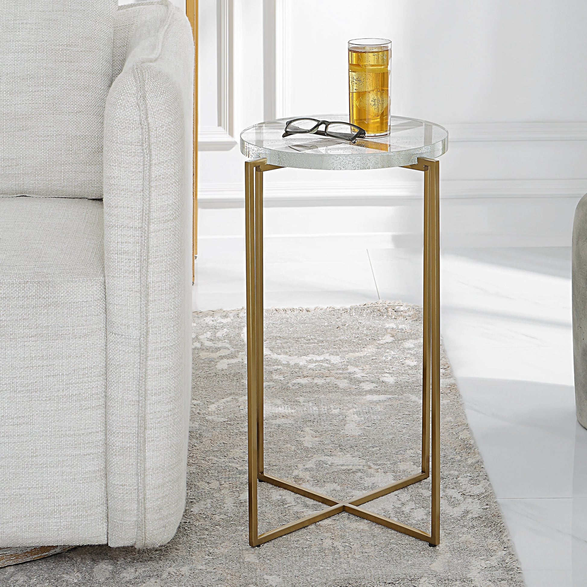 Star-Crossed Accent Table by Uttermost in gold. Made from seeded thick glass, stainless steel in a modern style.