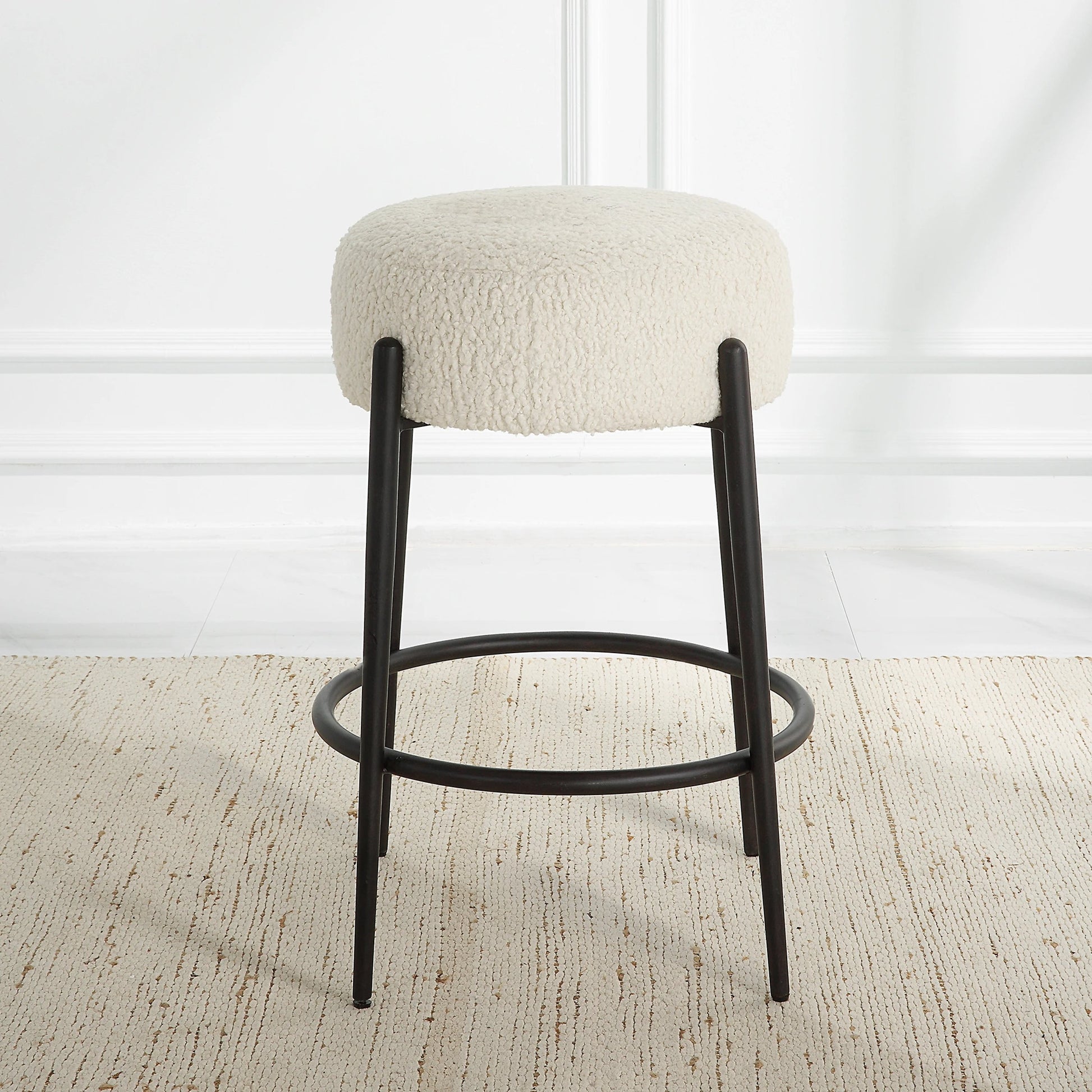 Arles Plush Counter Stool by Uttermost in white and satin black. Made from hardwood, plywood, fabric, metal, foam in a modern style.