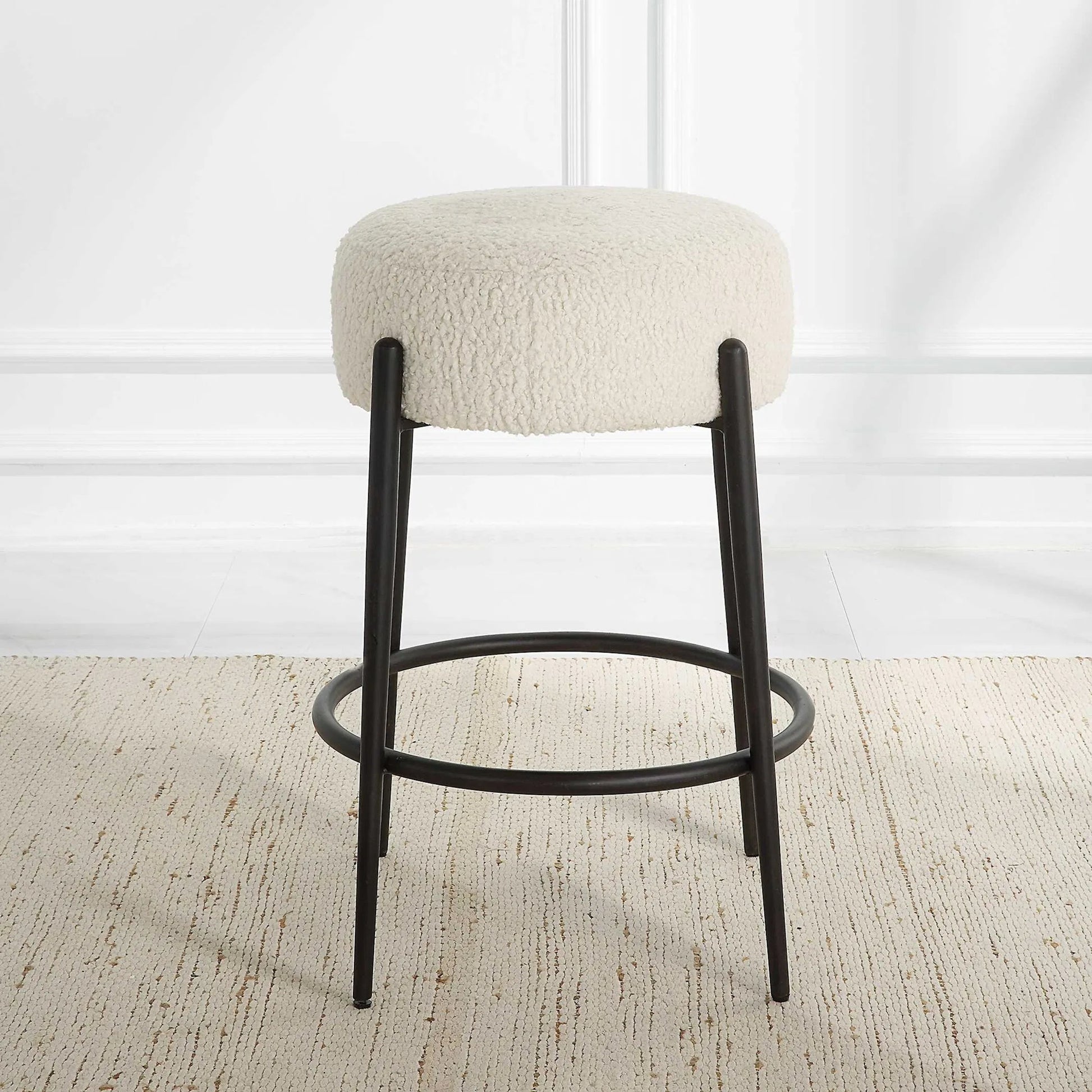 Arles Plush Counter Stool by Uttermost in white and satin black. Made from hardwood, plywood, fabric, metal, foam in a modern style.