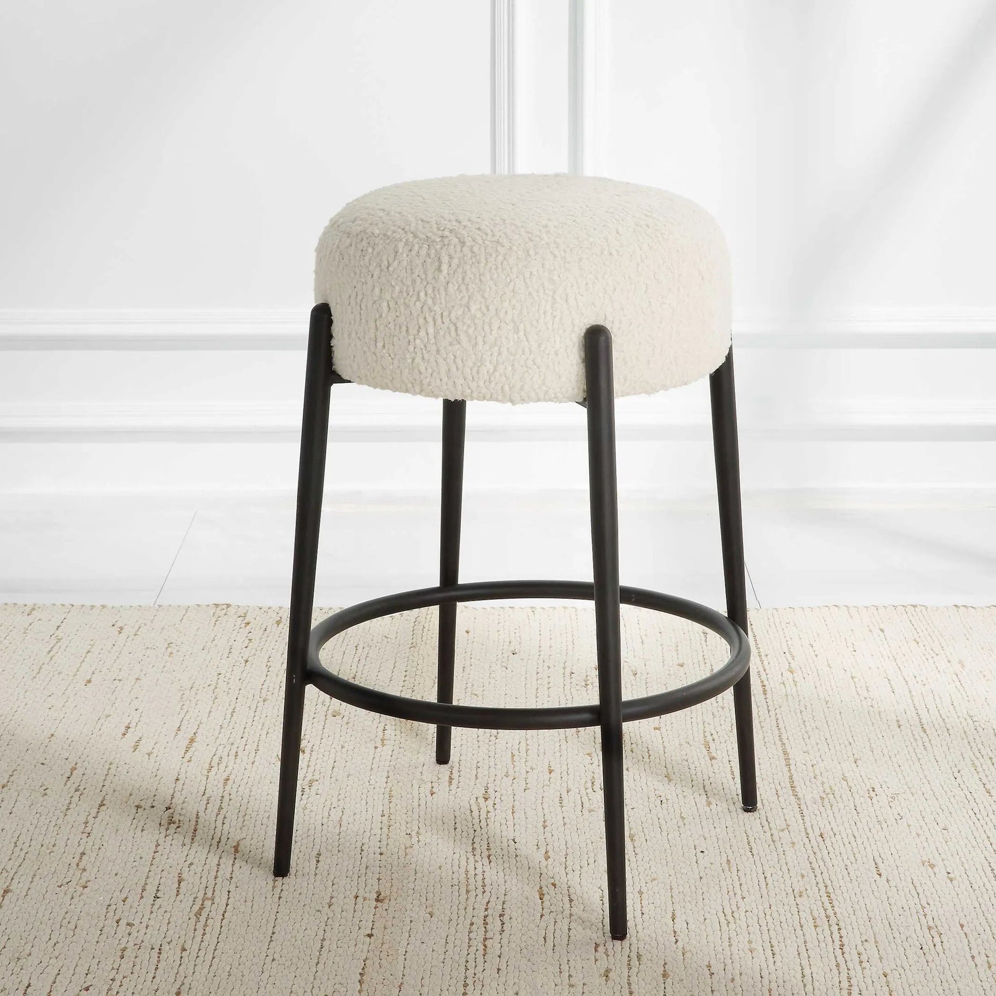 Arles Plush Counter Stool by Uttermost in white and satin black. Made from hardwood, plywood, fabric, metal, foam in a modern style.