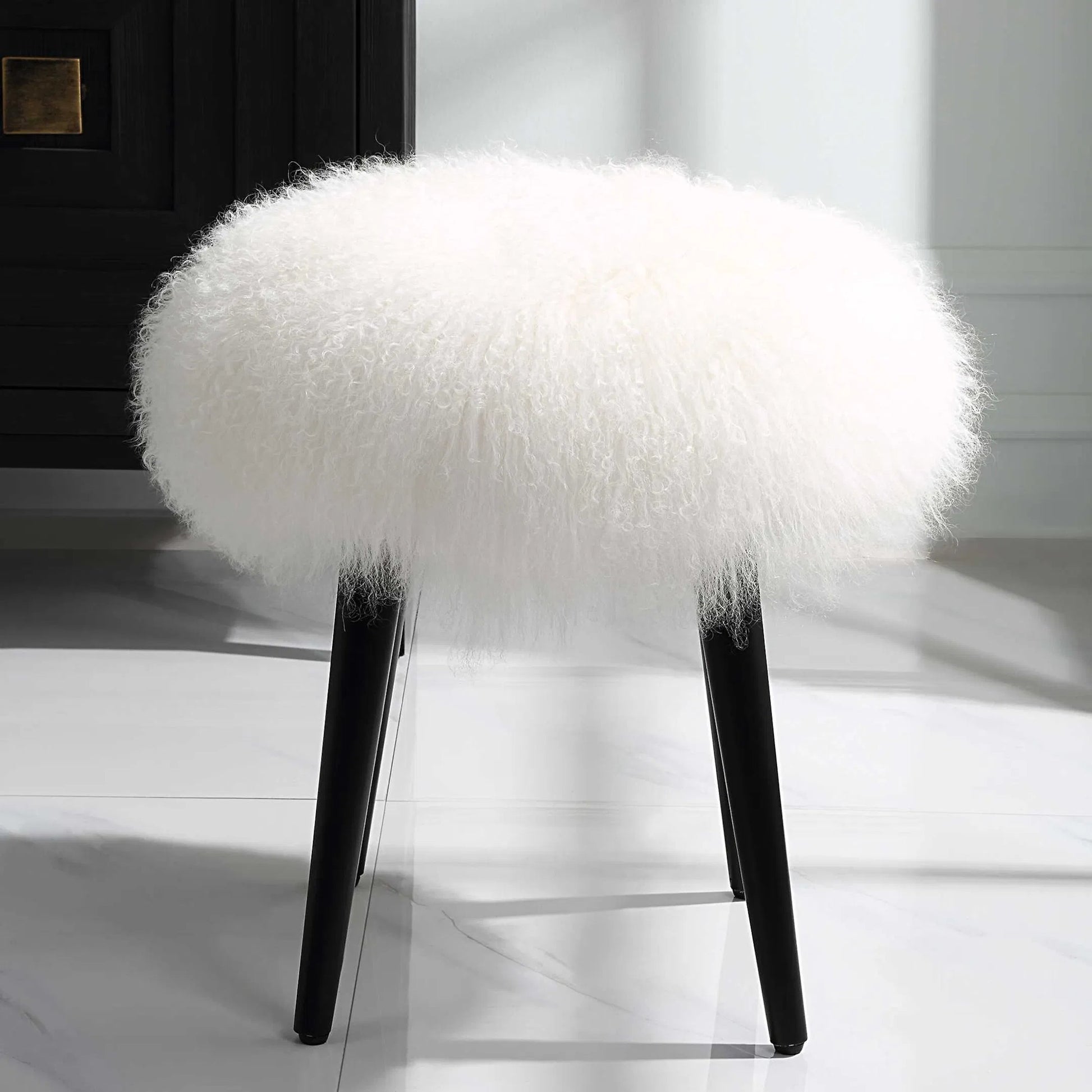Wooly Sheepskin Accent Stool by Uttermost in black. Made from rubber wood, real sheepskin, foam, plywood in a unique style.