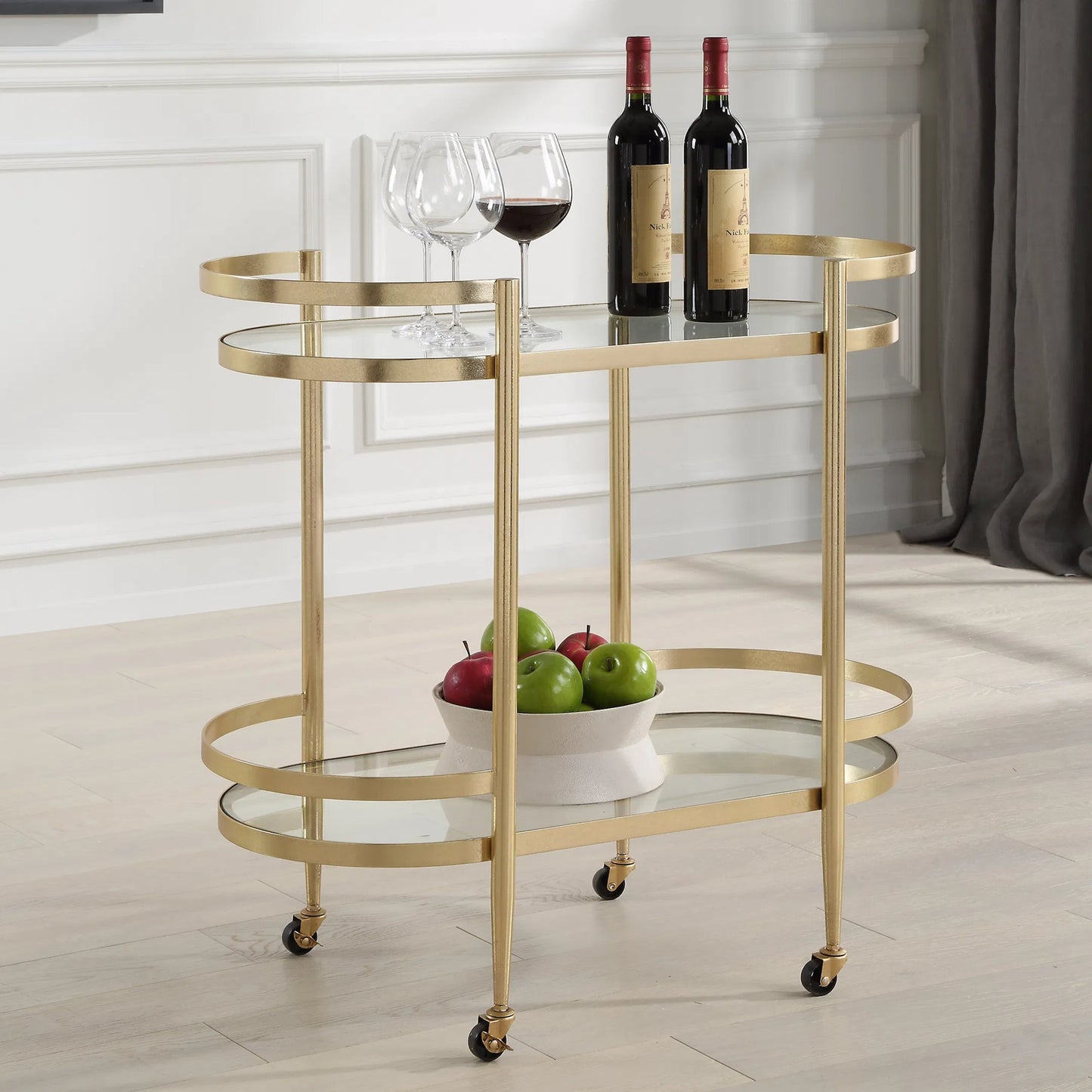 003 SI-2262311 | Lifestyle | Isabelle Bar Cart by Uttermost in gold leaf. Made from iron, tempered glass in a transitional style.