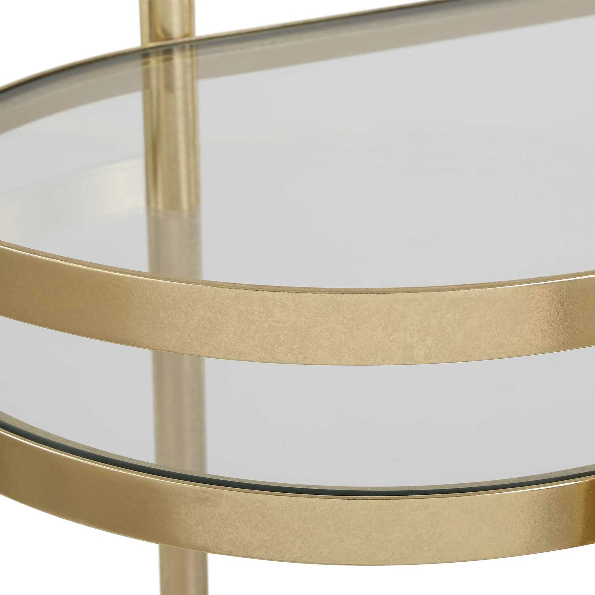 Isabelle Bar Cart by Uttermost in gold leaf. Made from iron, tempered glass in a transitional style.