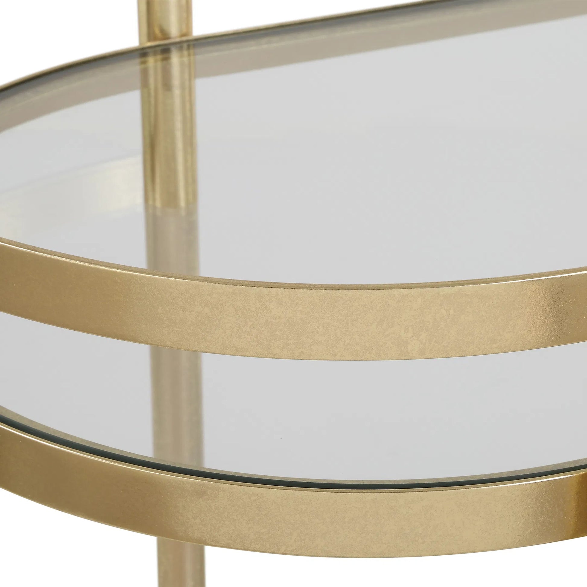 Isabelle Bar Cart by Uttermost in gold leaf. Made from iron, tempered glass in a transitional style.