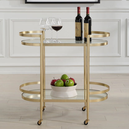 Isabelle Bar Cart by Uttermost in gold leaf. Made from iron, tempered glass in a transitional style.