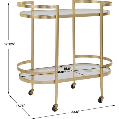 Isabelle Bar Cart by Uttermost in gold leaf. Made from iron, tempered glass in a transitional style.