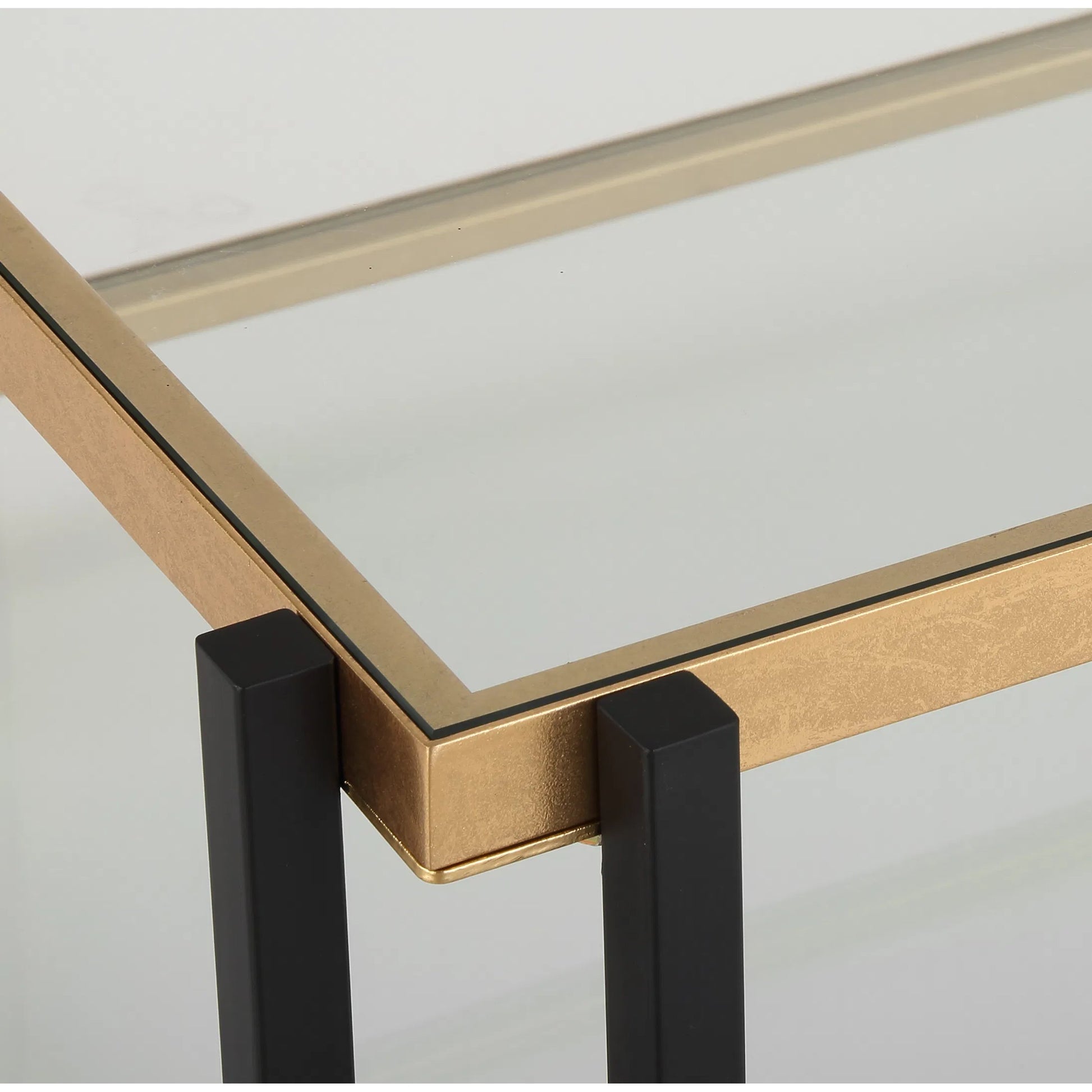 Kentmore Glass Coffee Table by Uttermost in gold leaf. Made from iron, tempered glass in a unique style.