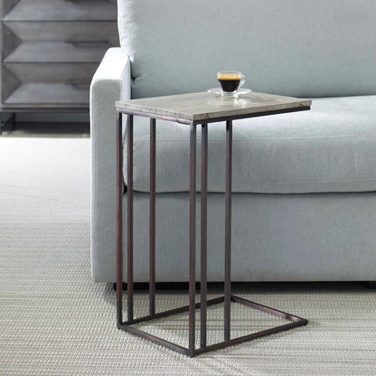 Theodore Travertine Accent Table by Uttermost in dark bronze. Made from marble, iron in a modern style.