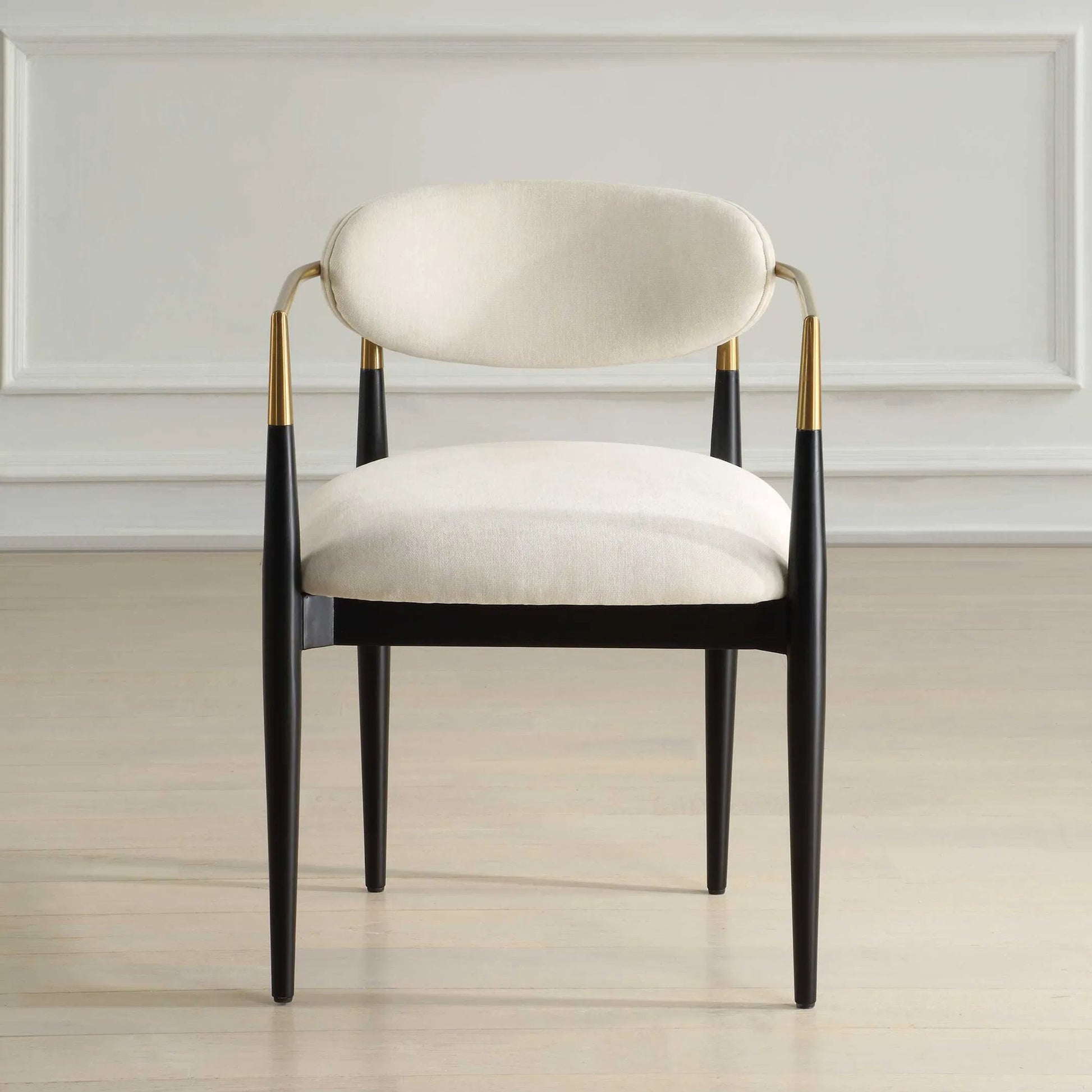 Moxie Dining Arm Chair by Uttermost in off white, brass. Made from rubber wood, foam, fabric, iron, plywood in a modern style.