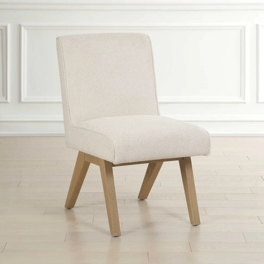 Blakely Armless Dining Chair by Uttermost in white. Made from oak solid, plywood, foam, fabric in a transitional style.