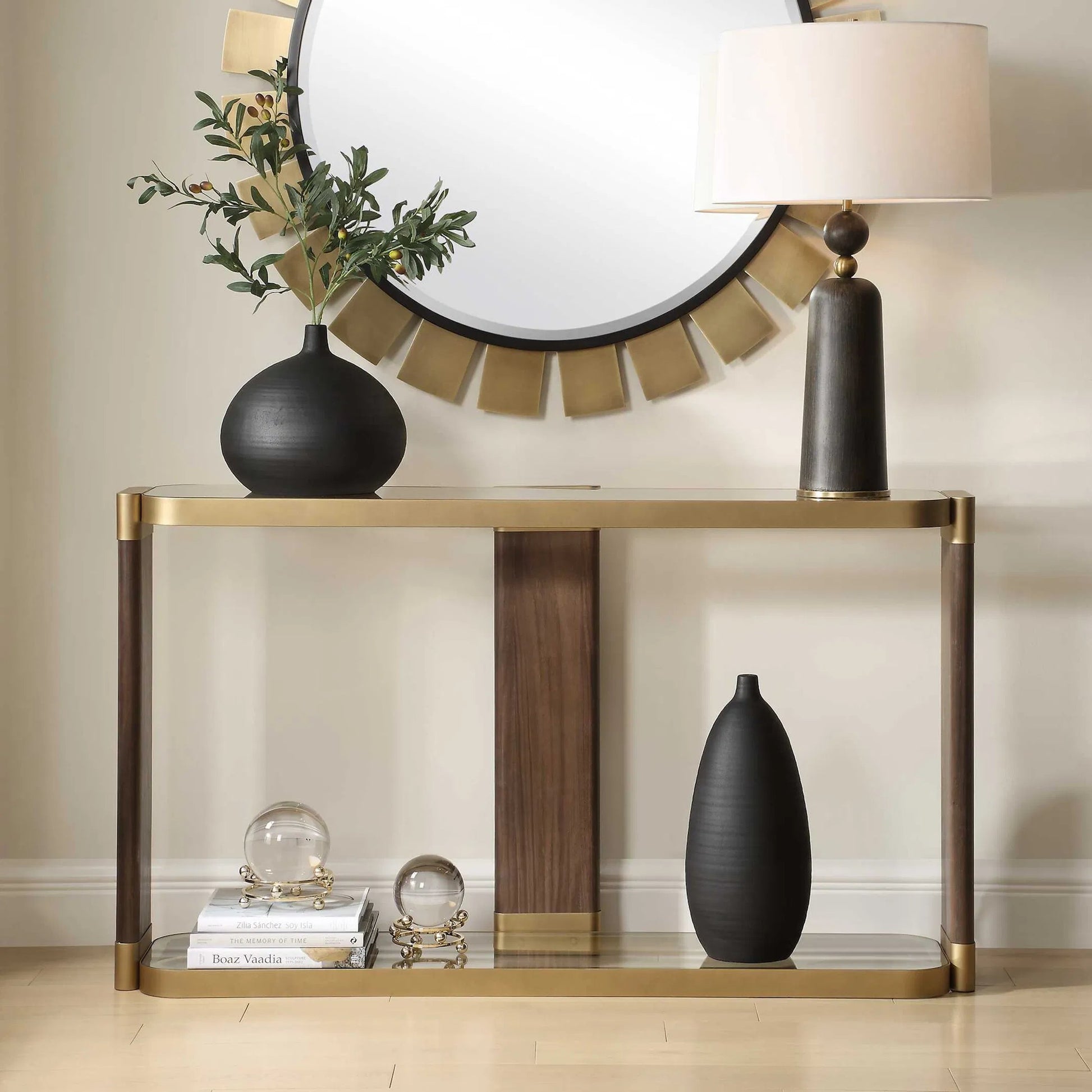Ryles Glass Console Table by Uttermost in gold. Made from metal, tempered glass, mdf, walnut veneer in a traditional style.