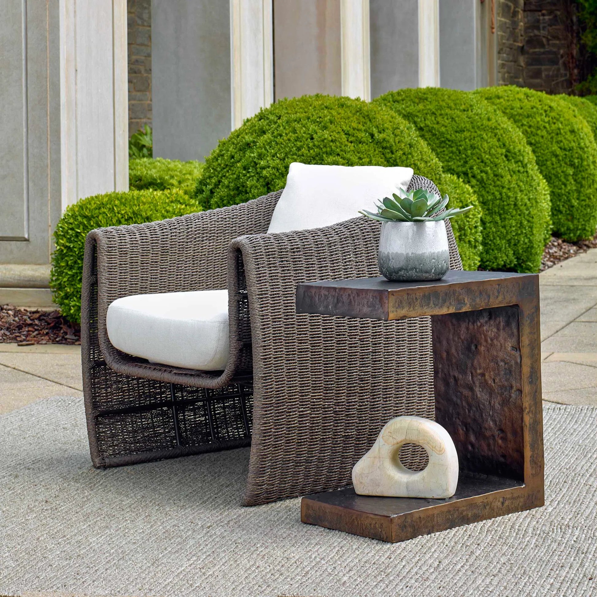 Obra Outdoor Side Table by Uttermost in dark bronze. Made from metal in a unique style.
