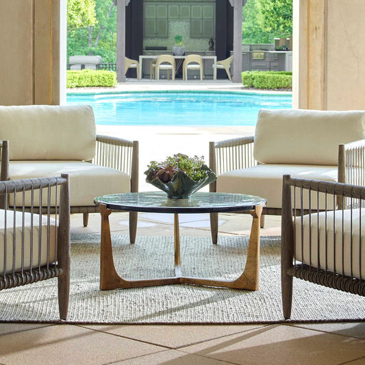 Bohdi Outdoor Coffee Table by Uttermost in brass. Made from metal, cast glass in a unique style.