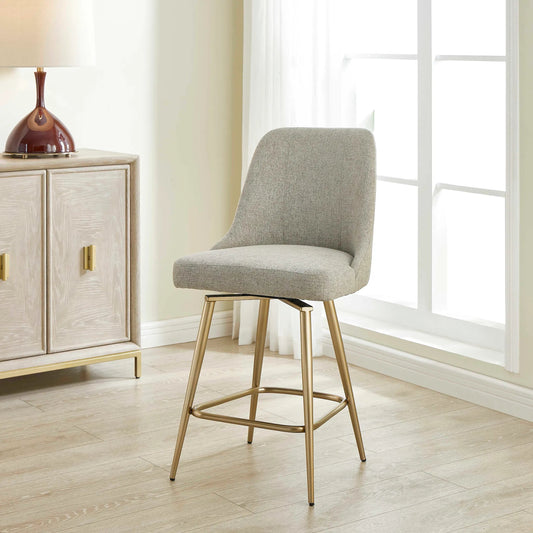 Bramwell Upholstered Counter Stool by Uttermost in brass, gray. Made from plywood, hardwood, fabric, foam, iron in a unique style.