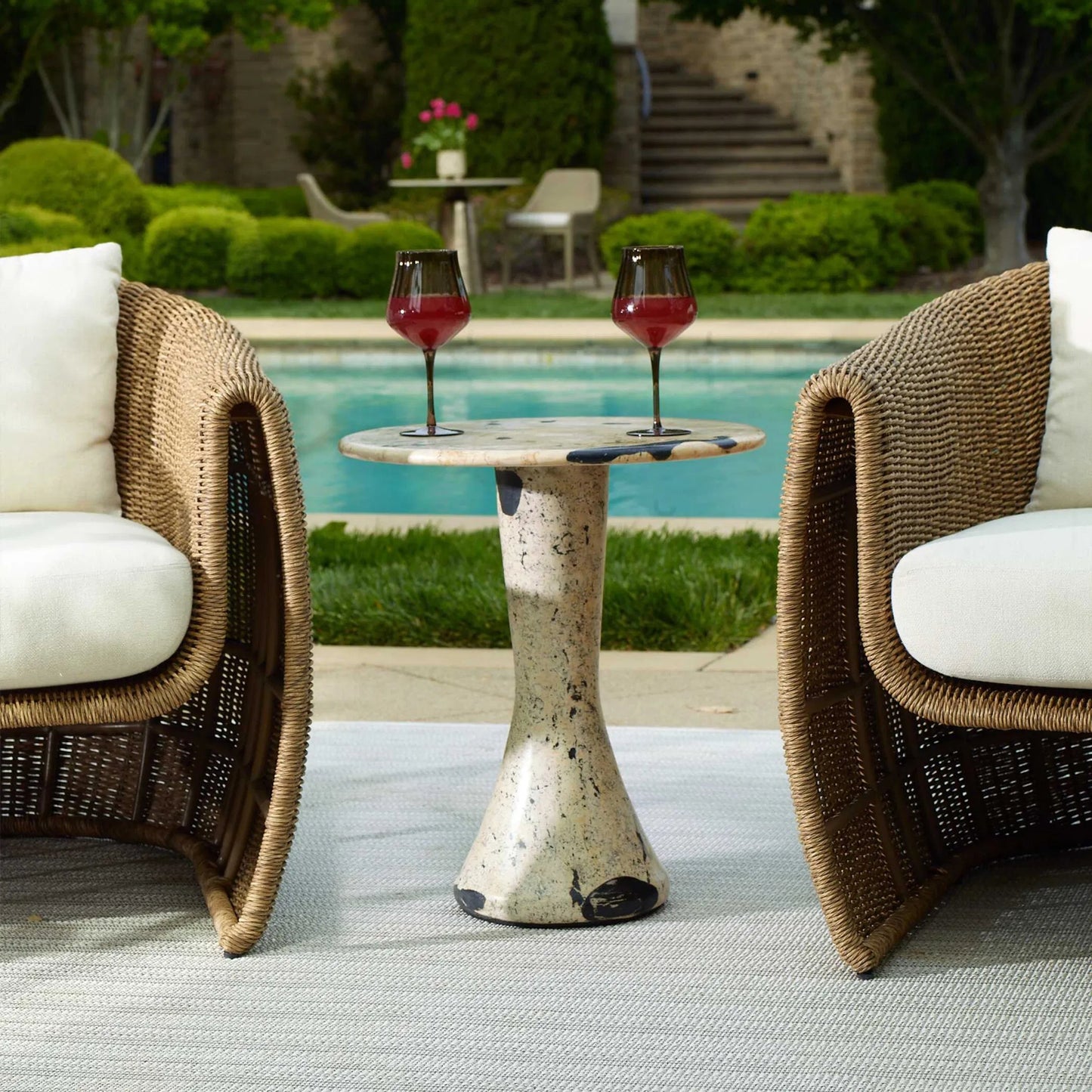 003 SI-2630676 | Lifestyle | Cadas Indoor/Outdoor Side Table by Uttermost in black, white and black. Made from coral stone, black resin in a unique style.