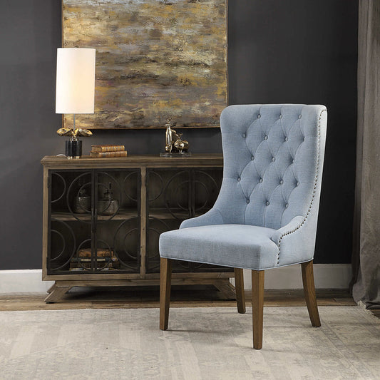Rioni Tufted Wing Chair by Uttermost. Made from fabric, oak wood, plywood, foam in a traditional style.