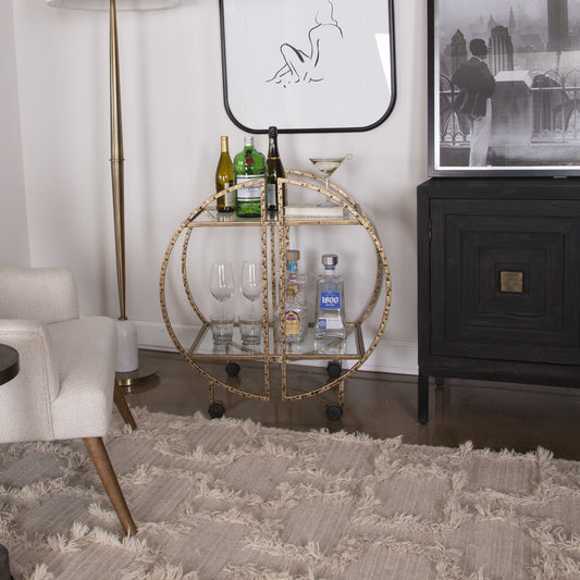 Zelina Bar Cart by Uttermost in gold. Made from 51% glass, 49% iron in a modern style.