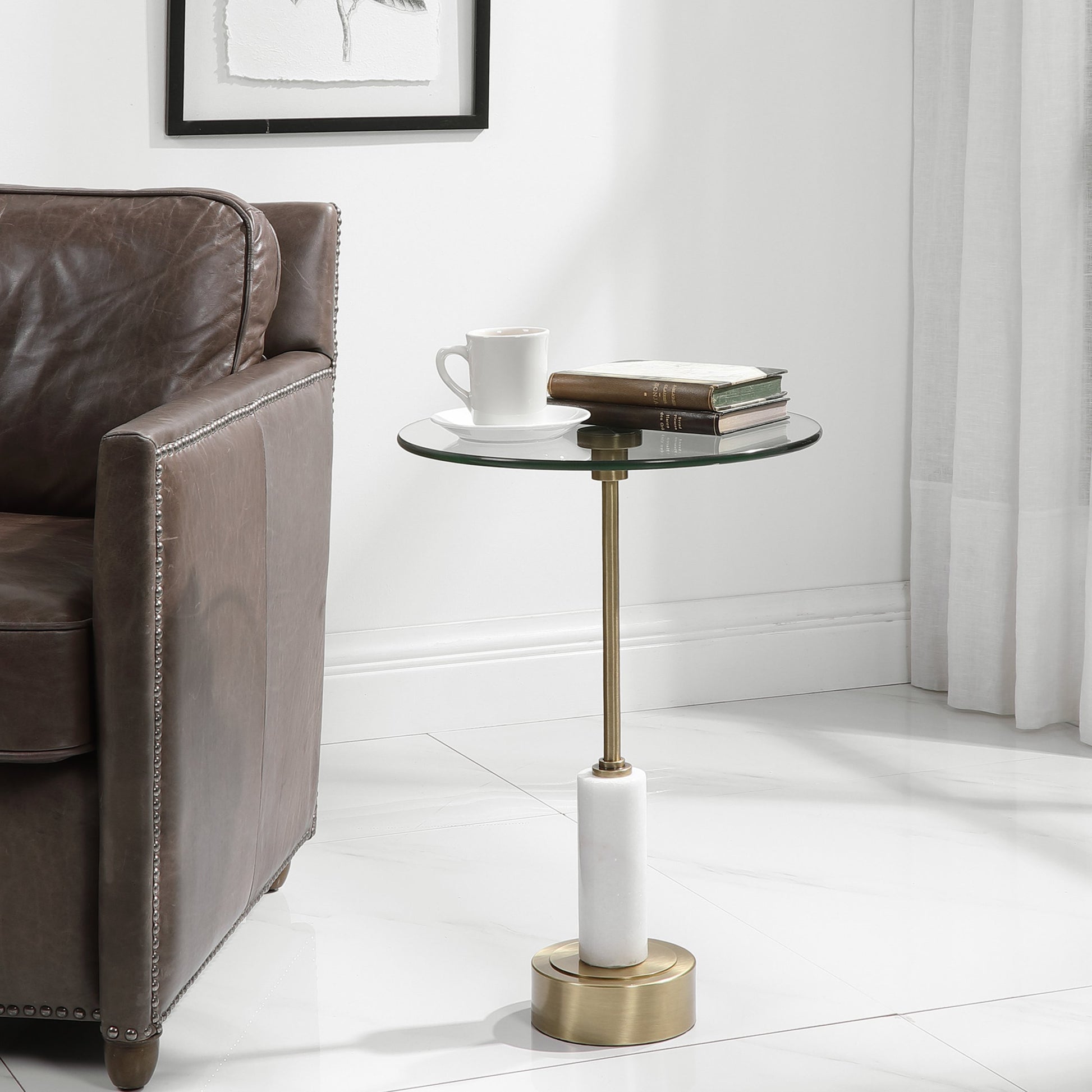 Portsmouth Accent Table by Uttermost in brushed brass. Made from iron, marble, glass in a modern style.