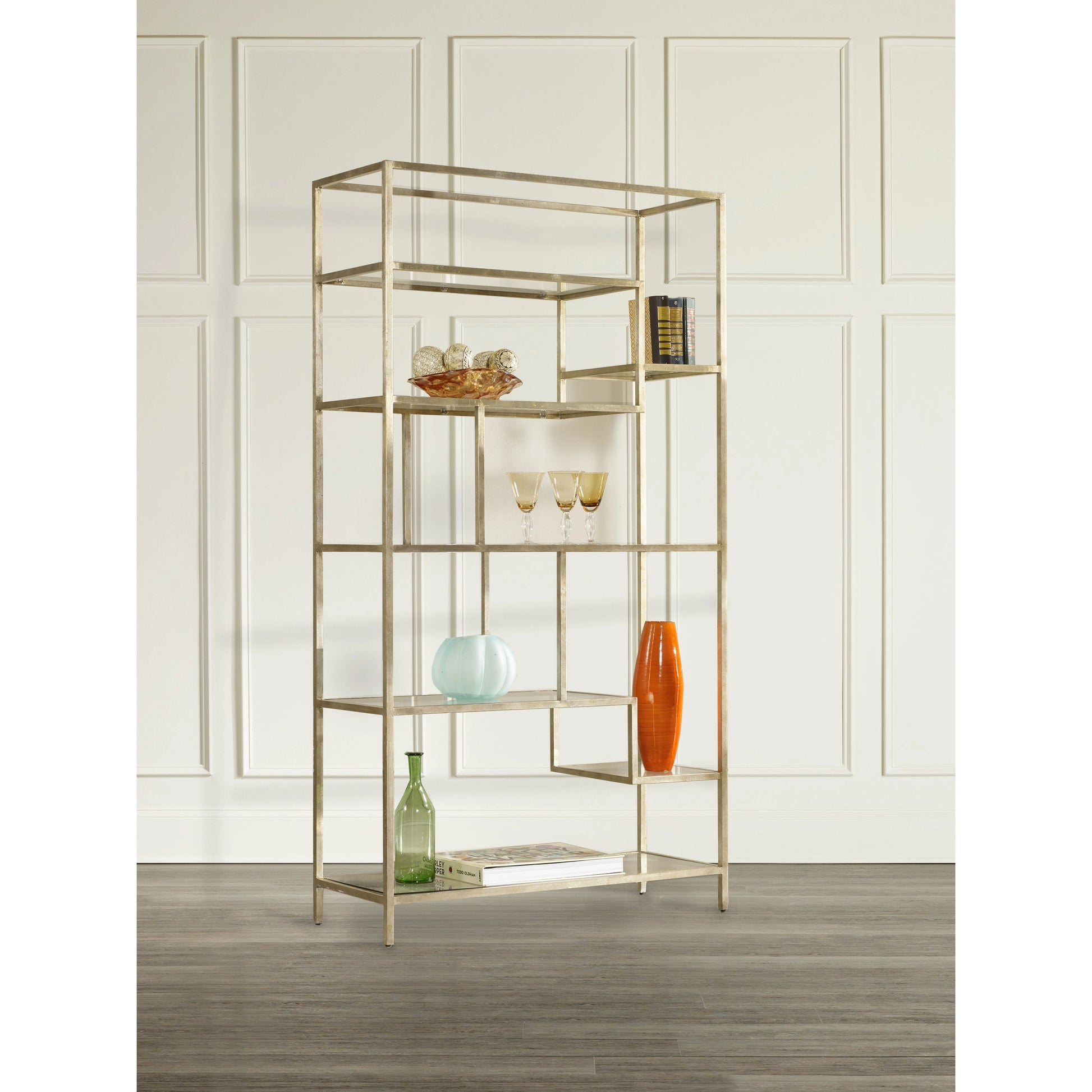 Etagere by Hooker Furniture in champagne gold. Made from iron with glass in a modern style.