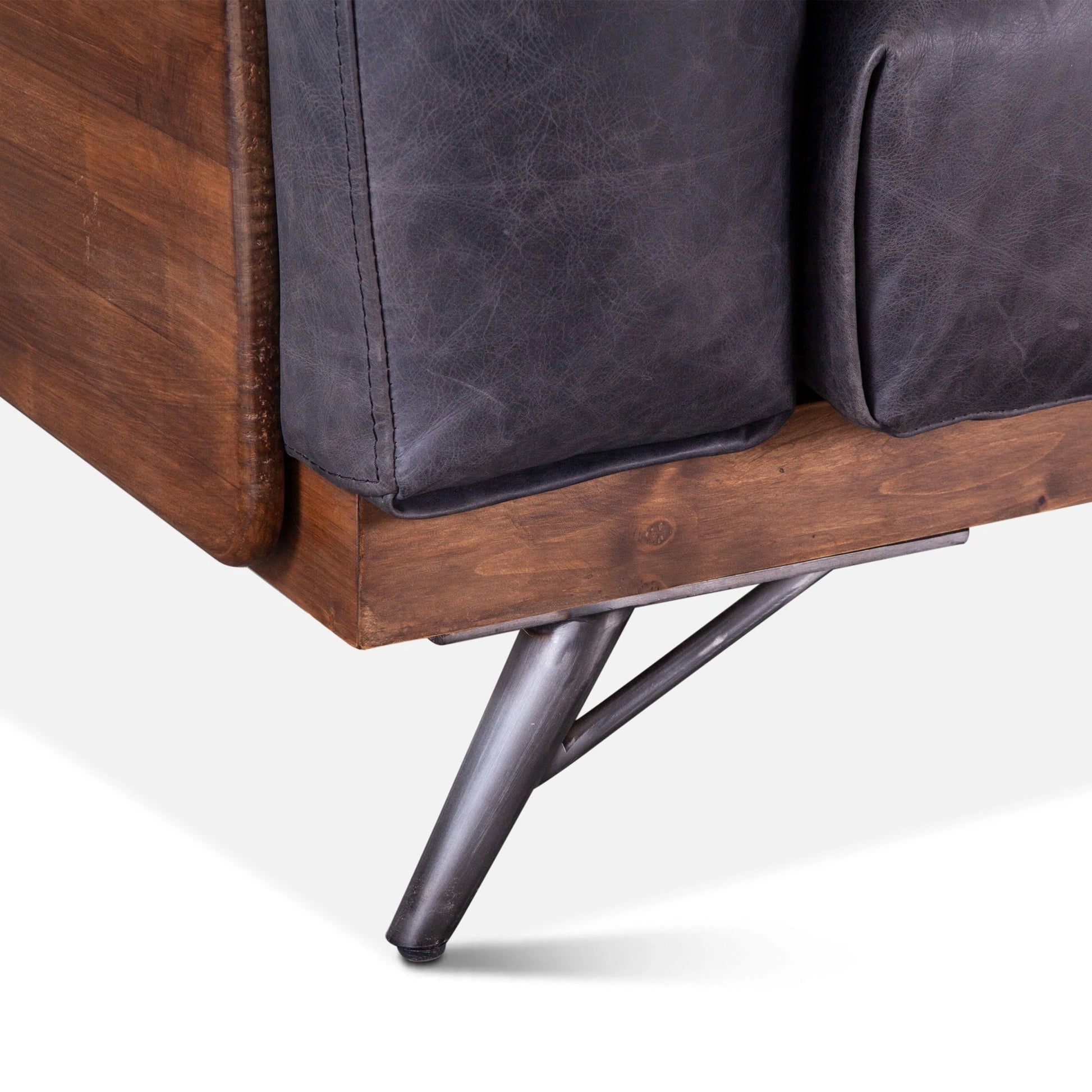 Chiavari Mid-Century Antique Ebony Leather Sofa by World Interiors in antique ebony, walnut, gunmetal. Made from leather, wood, iron in a transitional style.