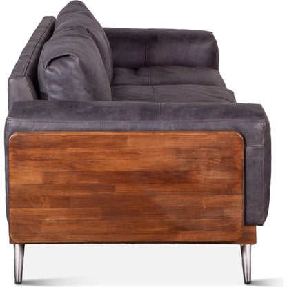 Chiavari Mid-Century Antique Ebony Leather Sofa by World Interiors in antique ebony, walnut, gunmetal. Made from leather, wood, iron in a transitional style.