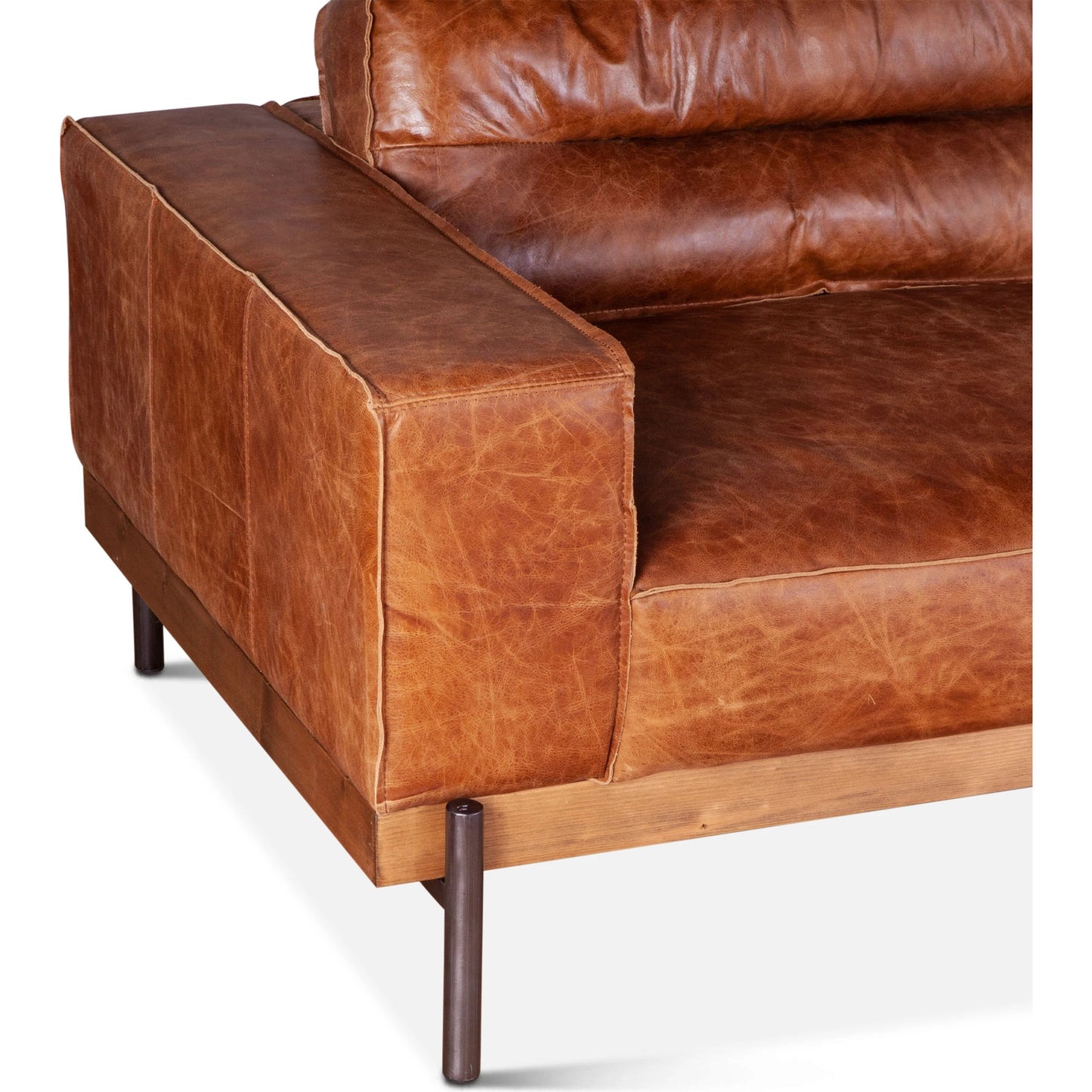 003 SI-2065543 | Closeup | Chiavari Modern Cognac Leather Sofa by World Interiors in cognac, antique zinc, oak. Made from leather, foam, oak wood & iron in a transitional style.