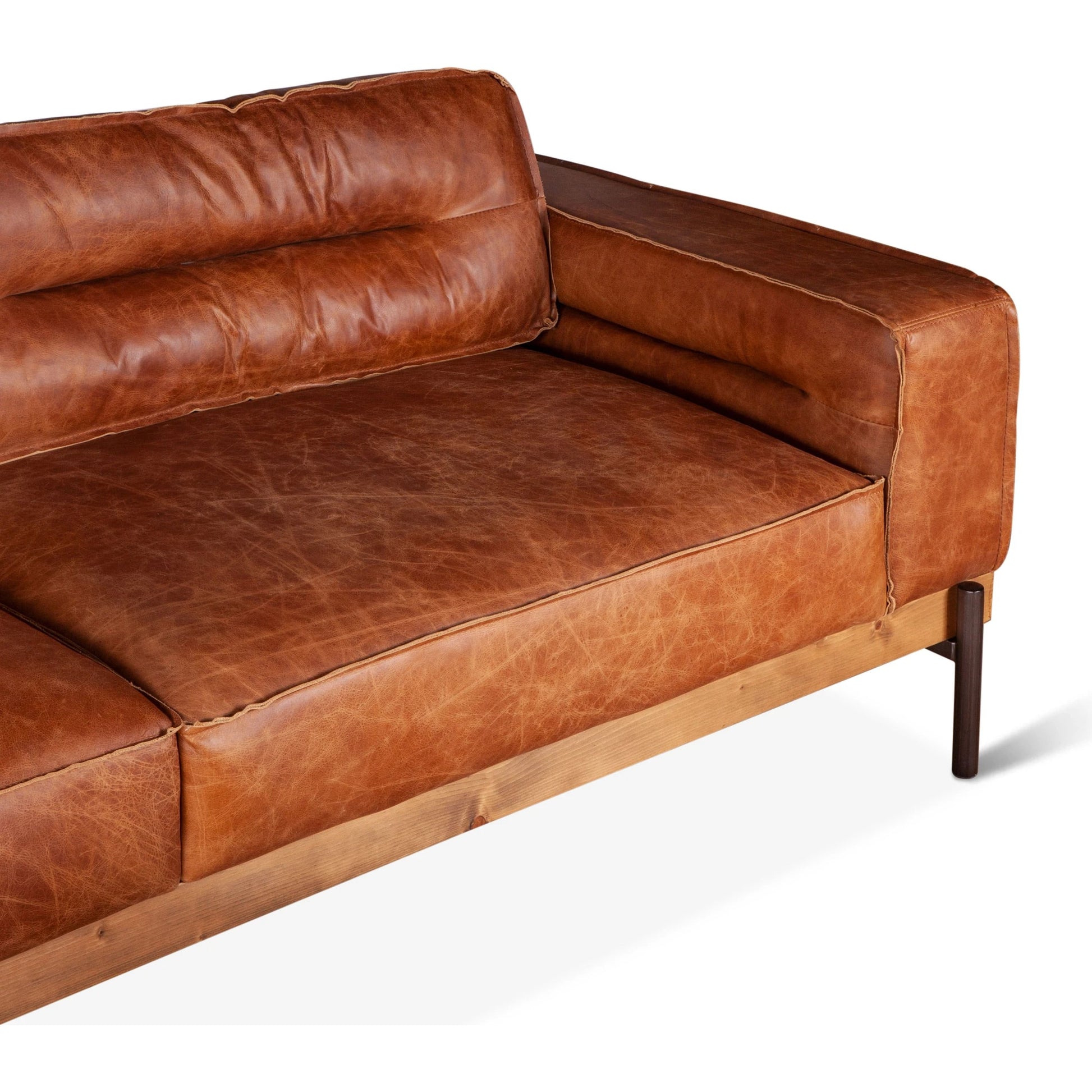 Chiavari Modern Cognac Leather Sofa by World Interiors in cognac, antique zinc, oak. Made from leather, foam, oak wood & iron in a transitional style.