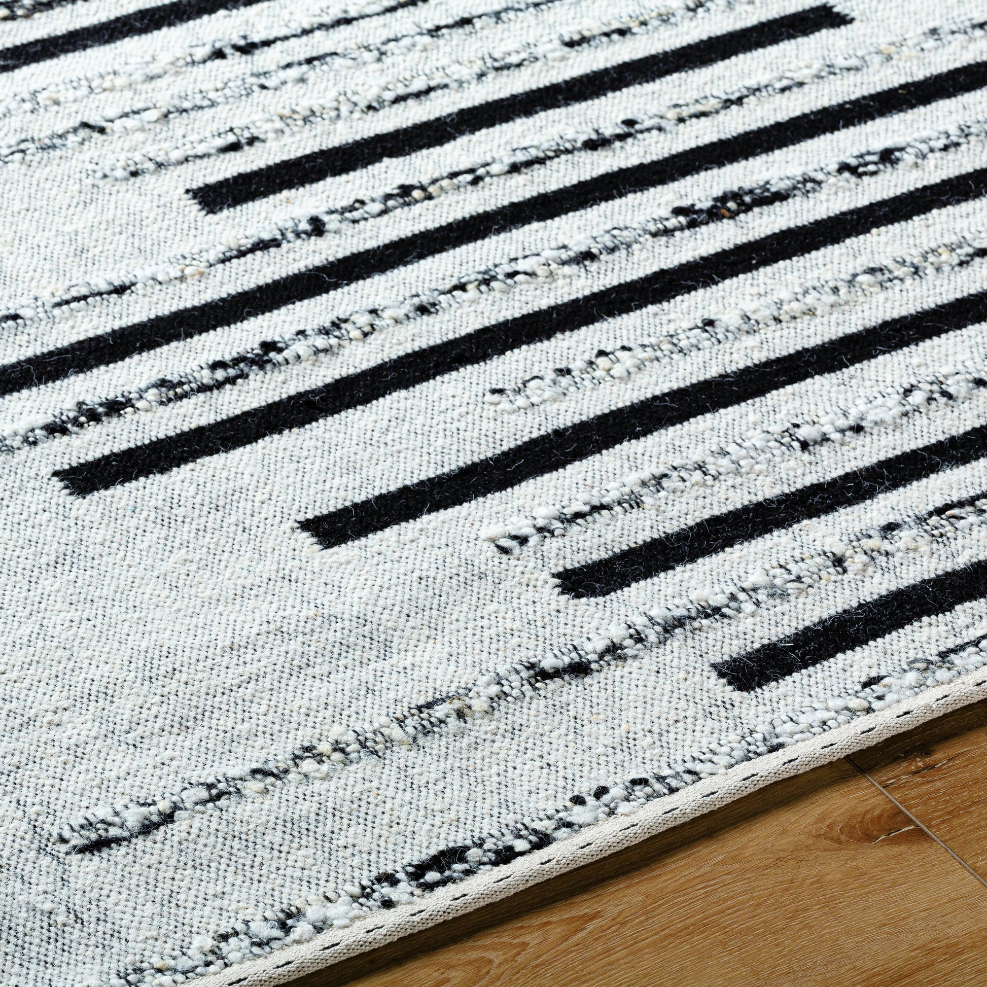 Goteborg GTG-2301 Rug by Surya in ivory, black. Made from face: 80% wool, 20% cotton, warp: 20% cotton in a unique style.