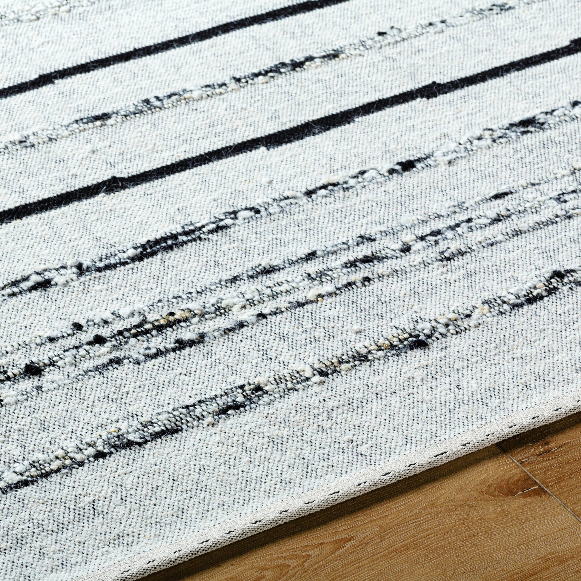Goteborg GTG-2302 Rug by Surya in ivory, black. Made from face: 80% wool, 20% cotton, warp: 20% cotton in a unique style.