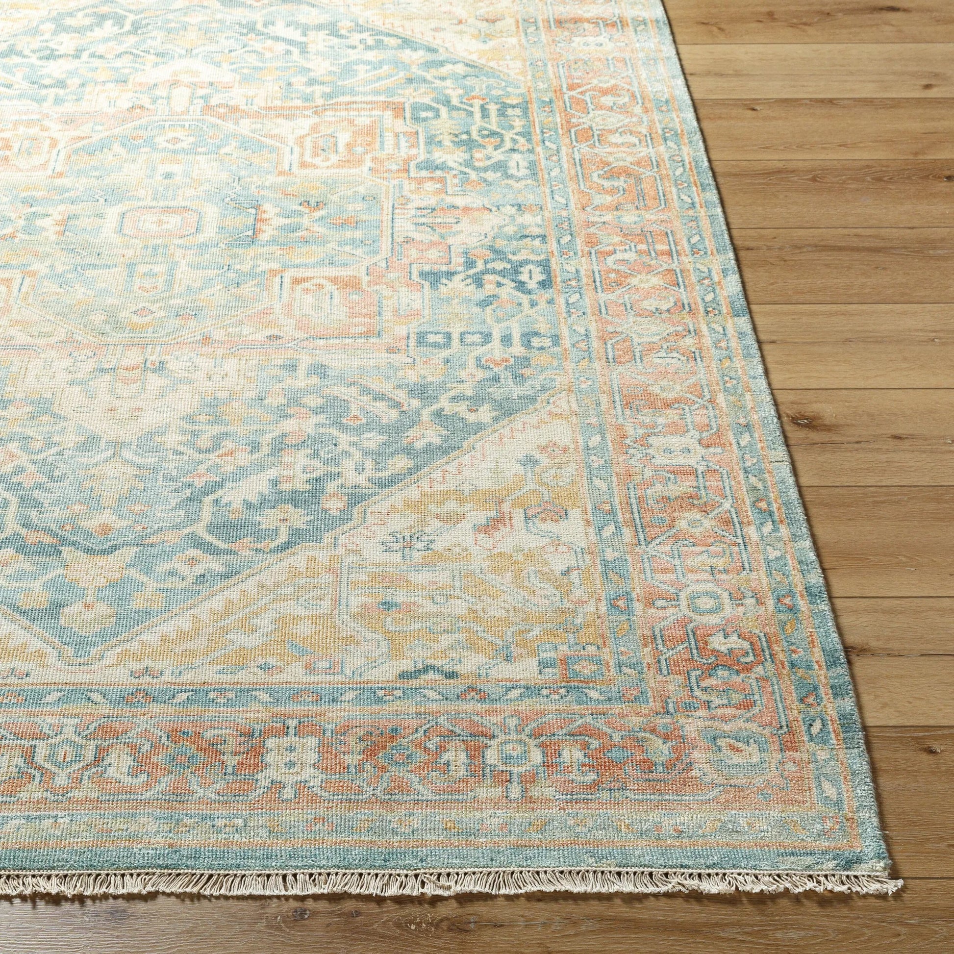 Hamadan Rug by Surya in saffron, camel, light beige, sage, tan. Made from 70% wool, 30% viscose in a traditional style.