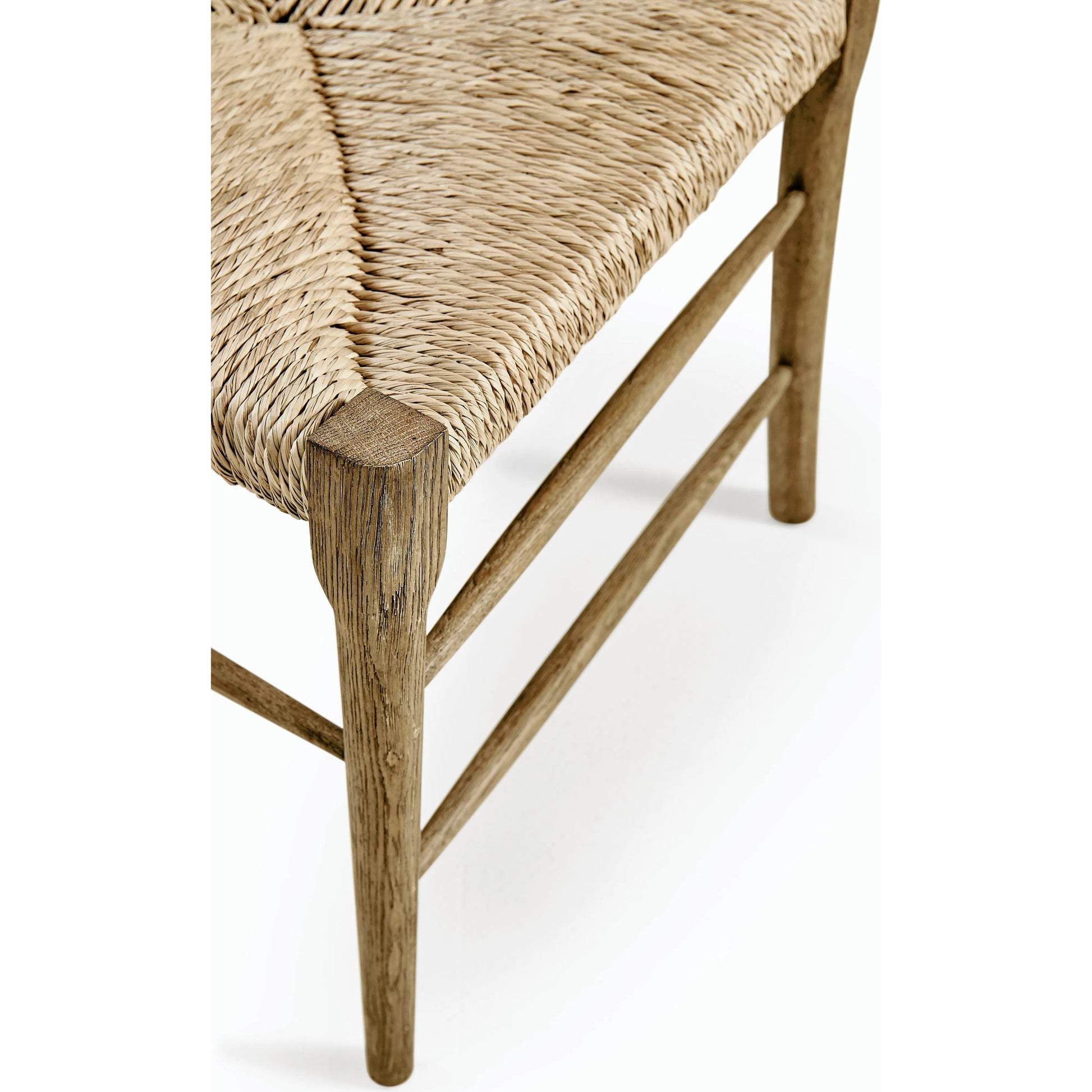 Timeless Doppler Ladderback Side Chair by Jonathan Charles in brown. Made from oak, fiber rush, foam, fabric in a coastal style.