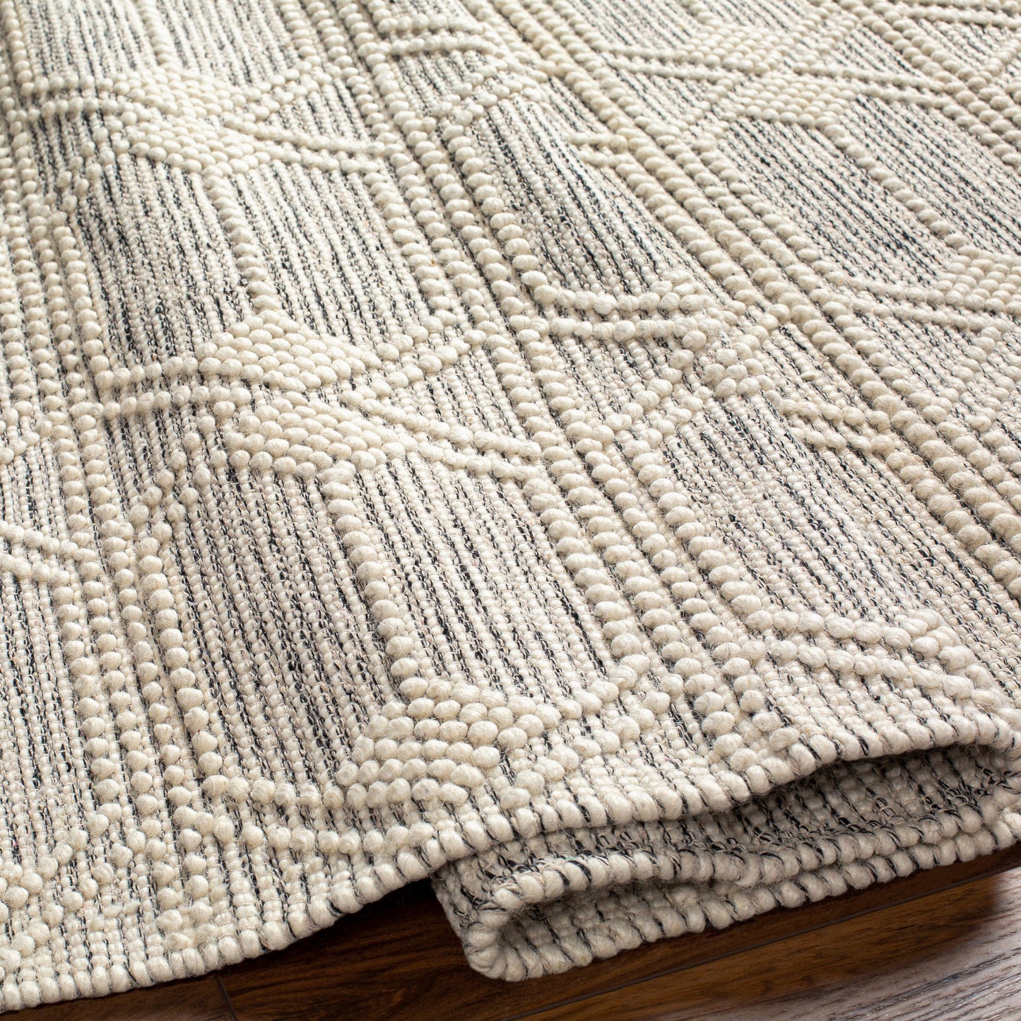 004 SI-1882582,SI-1882583,SI-1882587 | Closeup | Hemingway HMG-2310 Rug by Livabliss in ivory, black. Made from 60% wool, 40% polyester in a unique style.