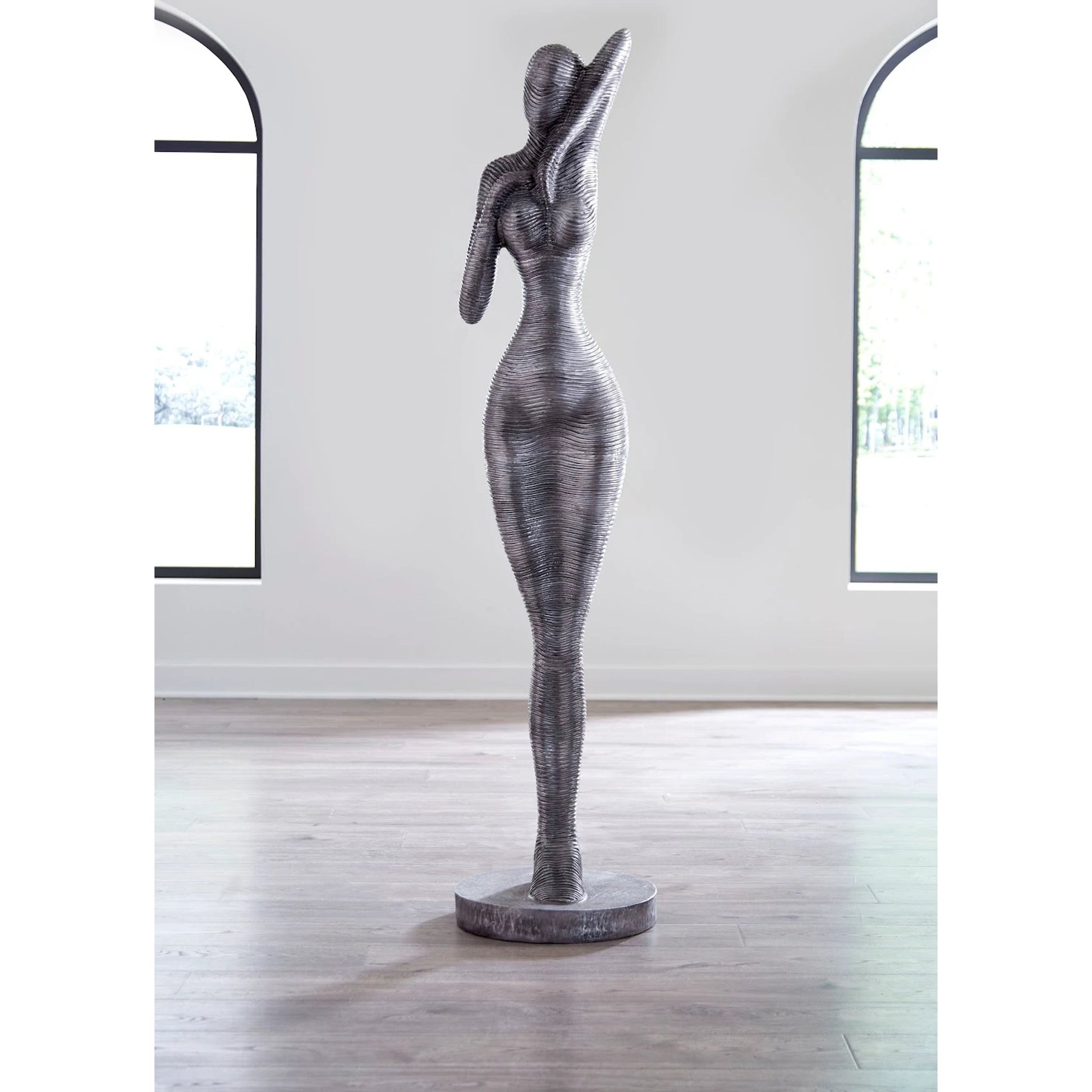 Admiring Standing Sculpture by Phillips Collection in silver. Made from metal, aluminum in a modern style.
