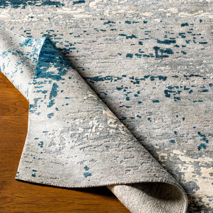 Imola Rug - 26077 by Surya in light beige, gray, light gray, dark blue, teal, charcoal. Made from 90% viscose, 10% nz wool in a unique style.