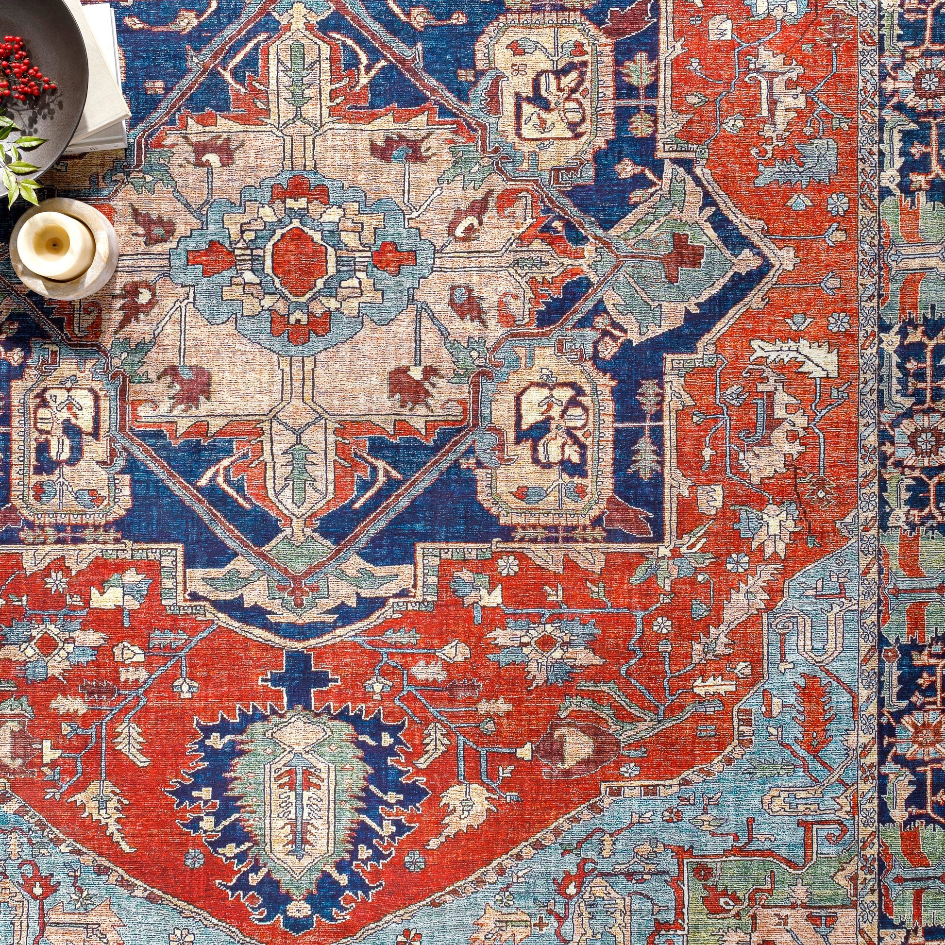 Iris Rug by Livabliss in red, burnt orange, dark blue, ink blue, pale blue, green. Made from 100% polyester in a traditional style.